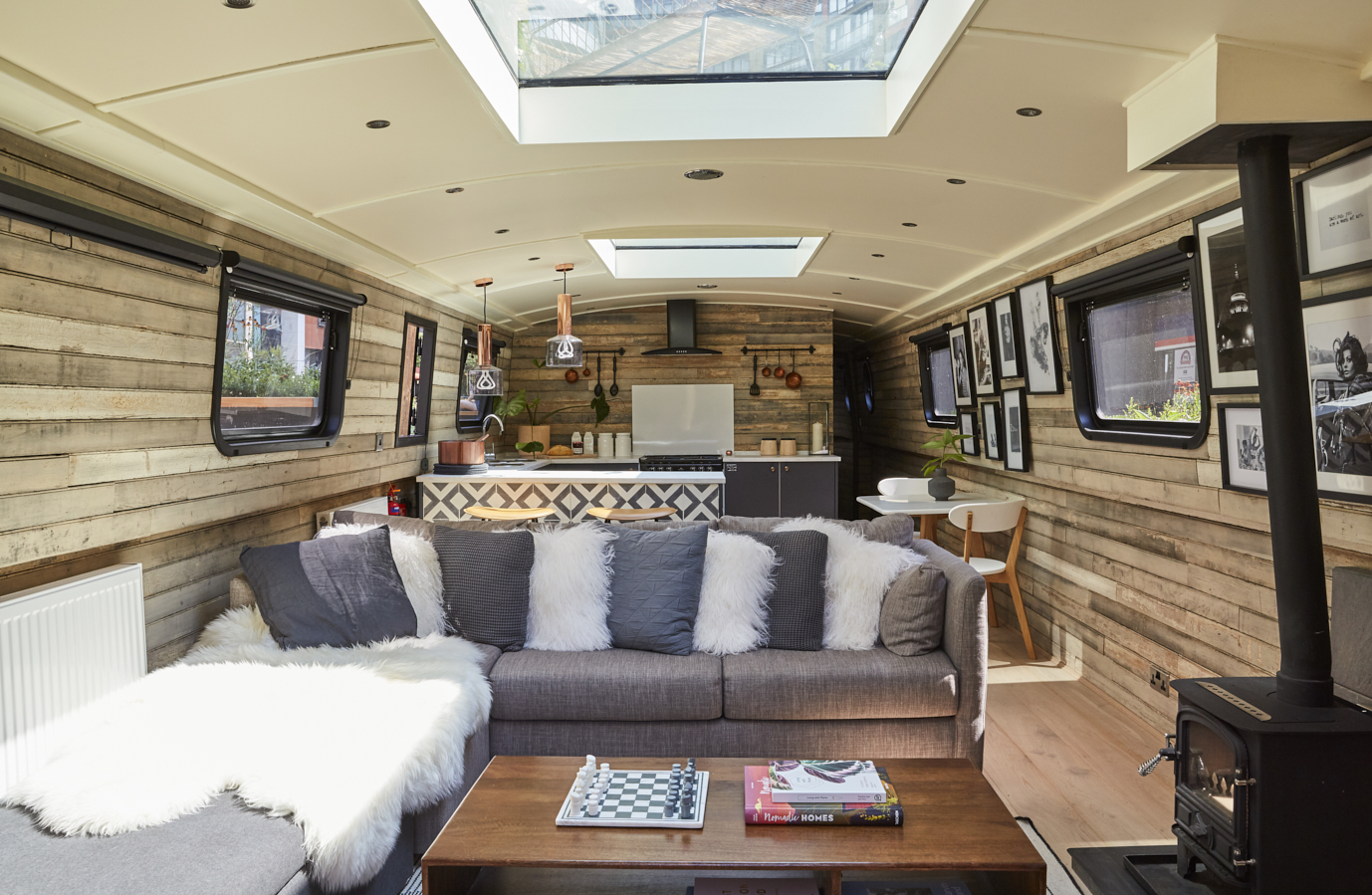 Boutique hotel boat interior with rustic wood, ideal for creative meetings in London.