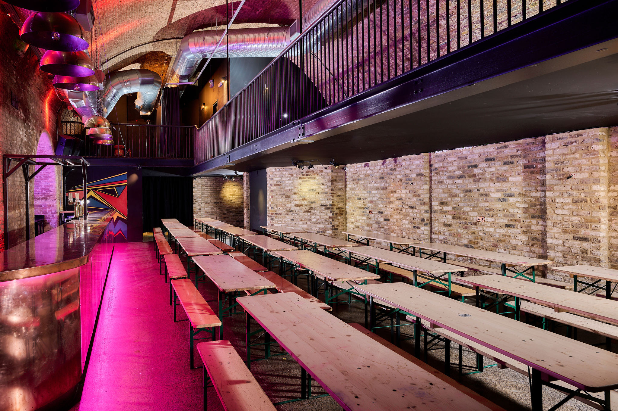 Arch 3 at The Steel Yard: vibrant event space with communal tables for networking and gatherings.