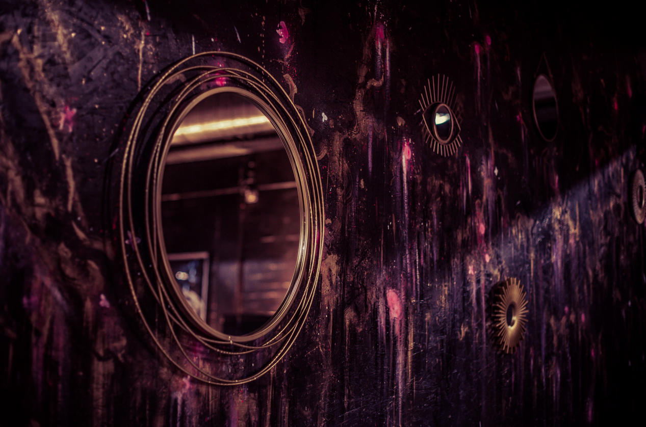 Cocktail Club Reading: artistic wall with circular mirrors, perfect for stylish events.