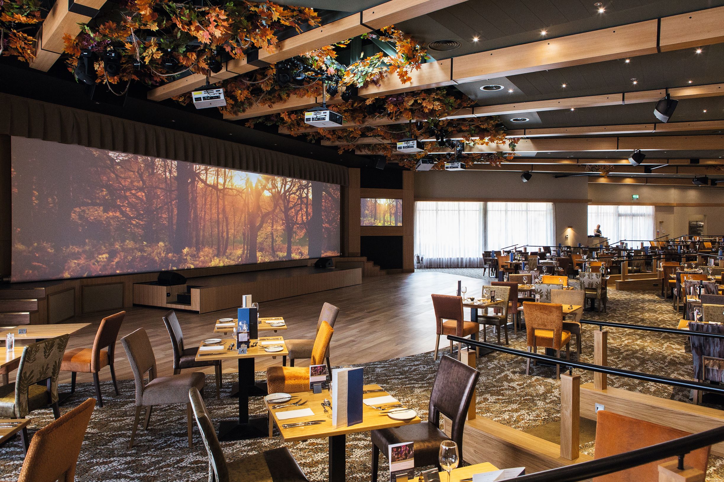 Elegant event space at The Evesham, featuring a large projection screen for gatherings.