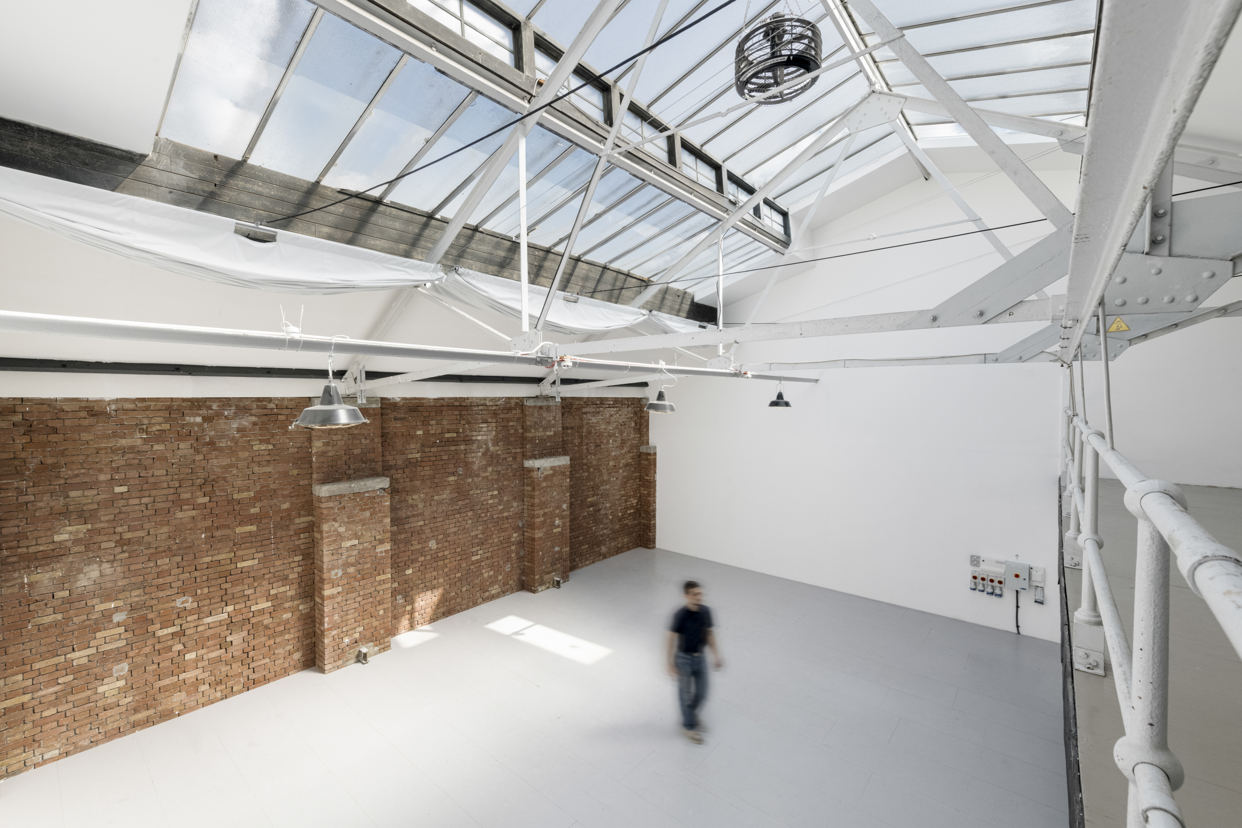 Spacious industrial event space with high ceilings, ideal for corporate meetings and workshops.