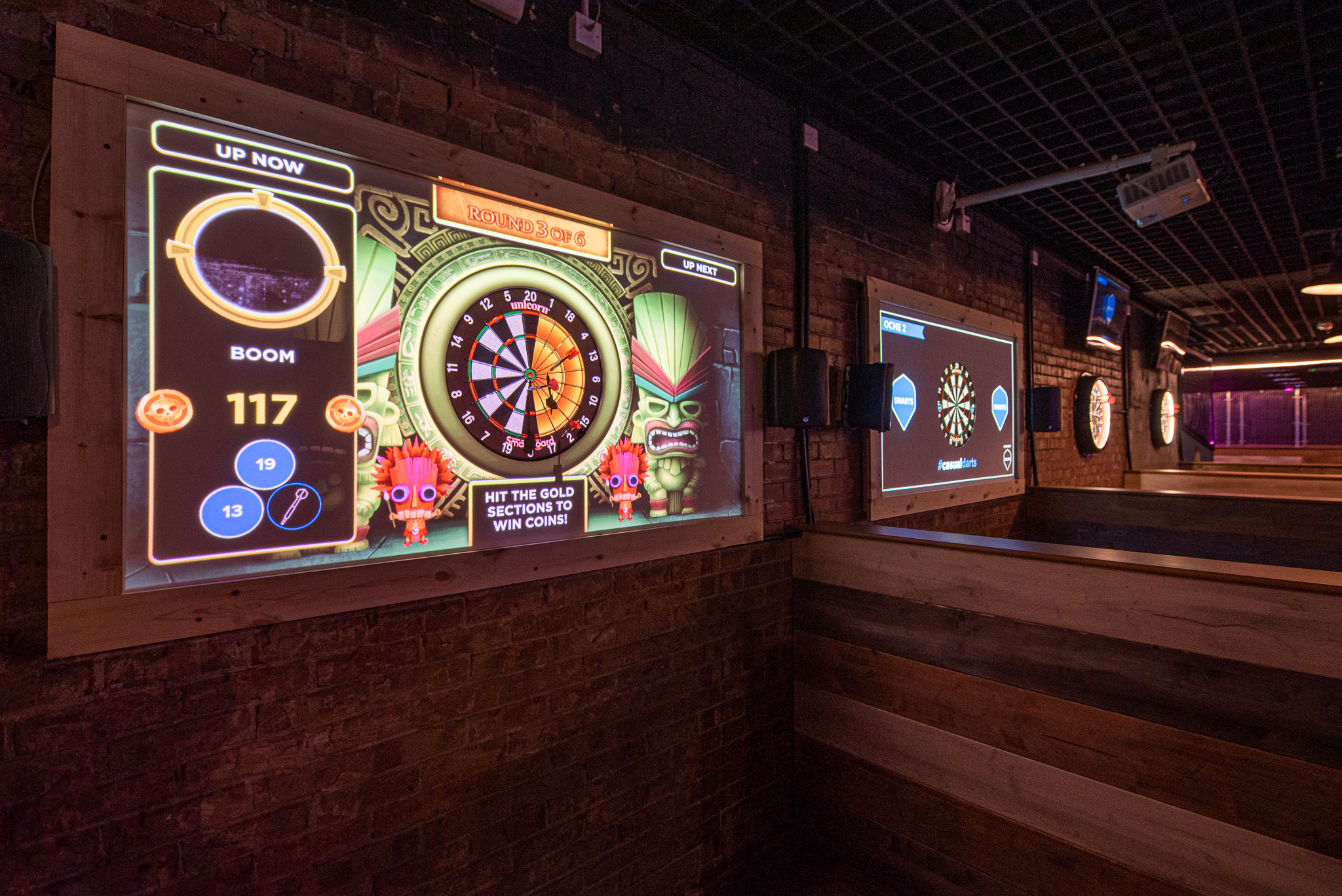 "Vibrant interactive dart games in Boom Battle Bar's event space for corporate outings."