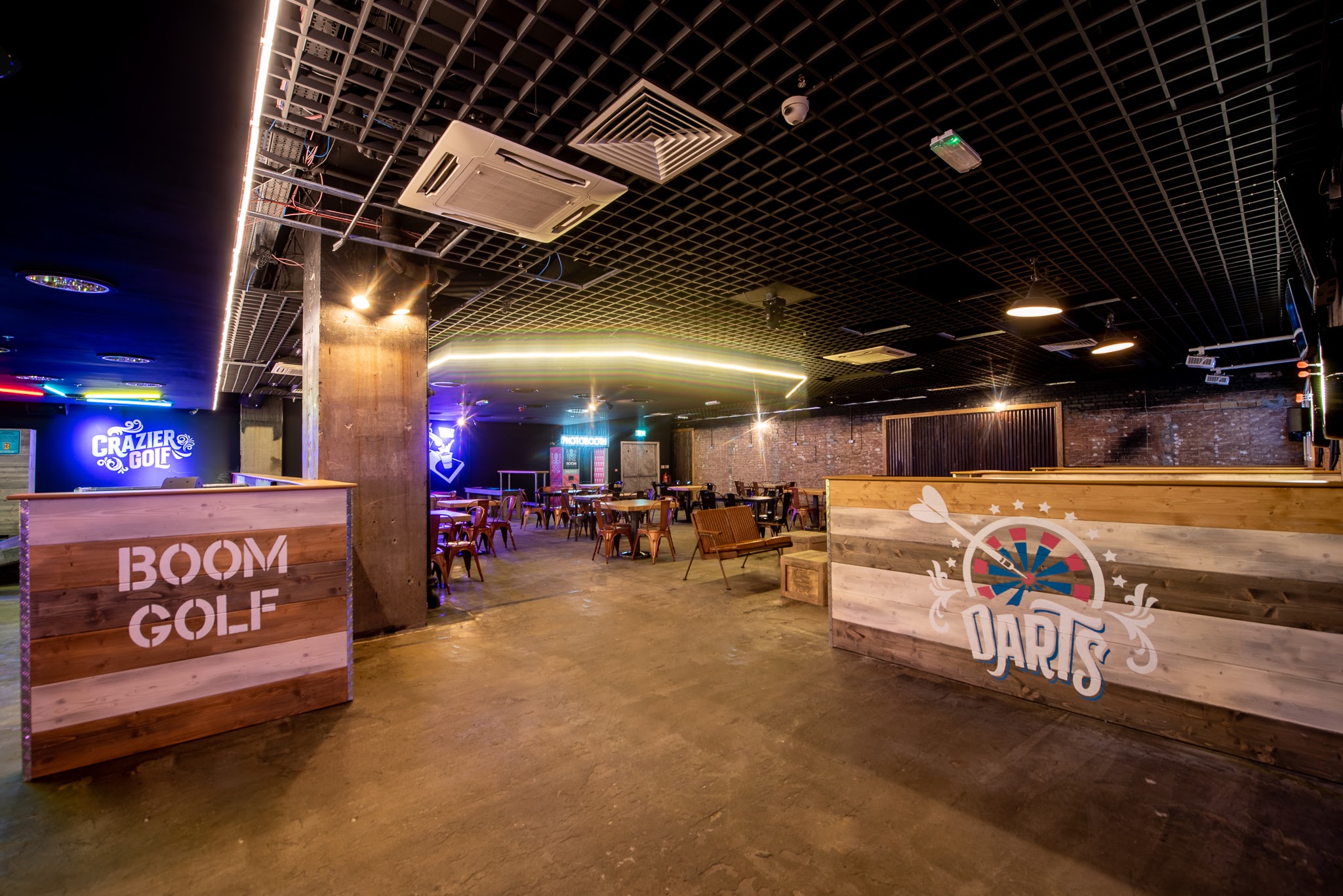 Vibrant Boom Battle Bar event space with darts and golf for social gatherings.