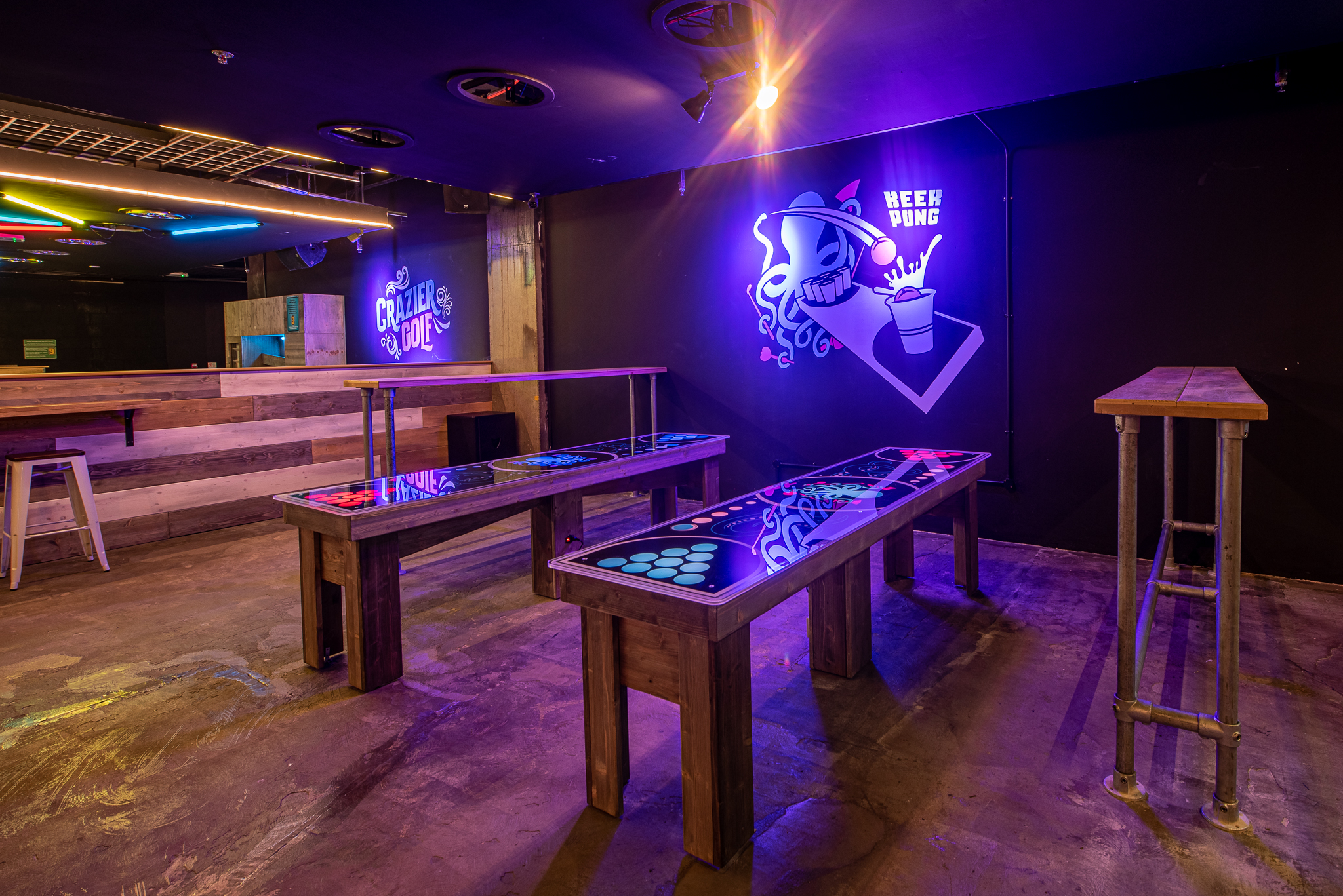 Vibrant Boom Battle Bar event space with illuminated tables for creative workshops.
