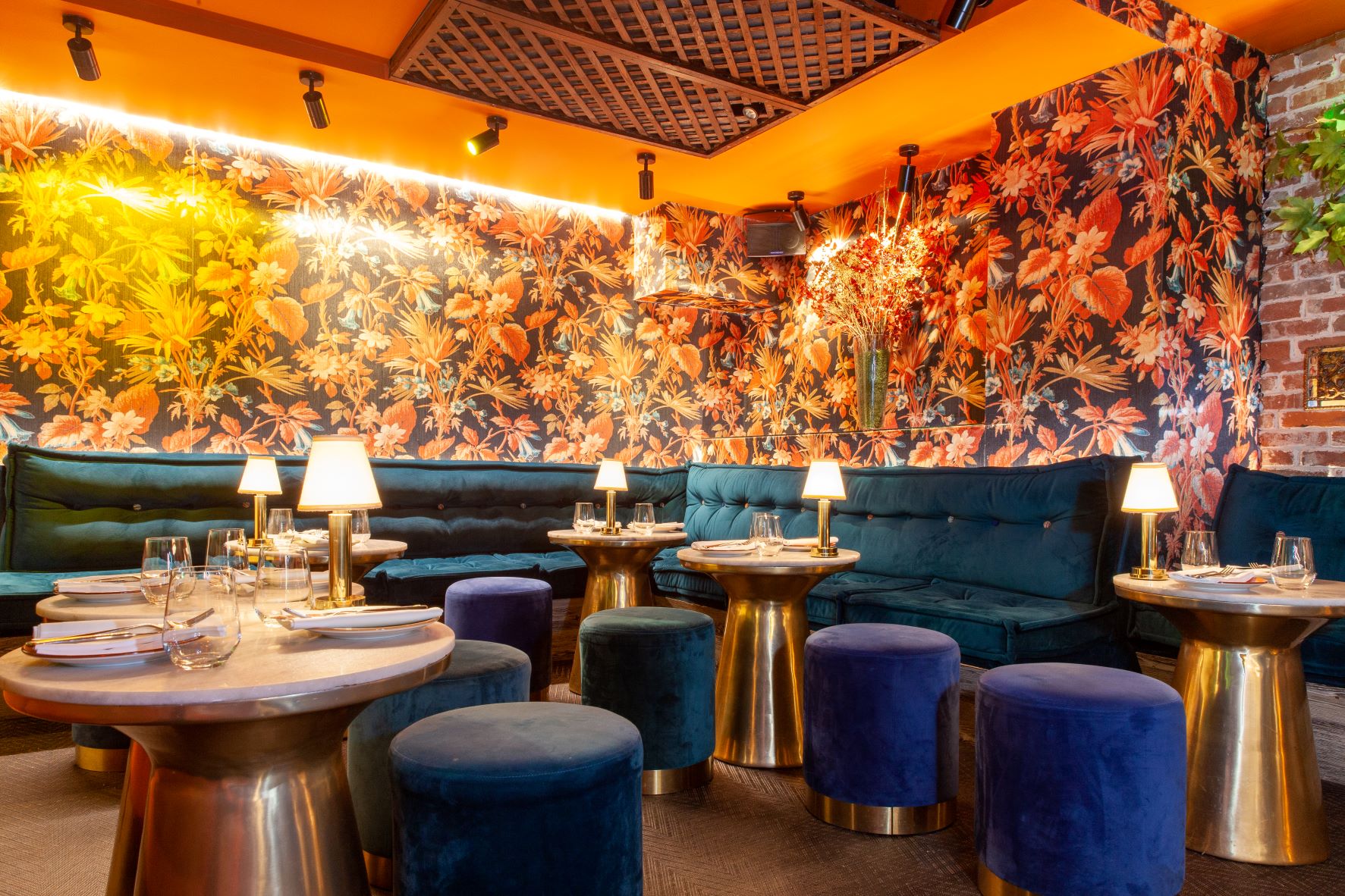 Vibrant restaurant interior with floral wallpaper, ideal for networking dinners and events.