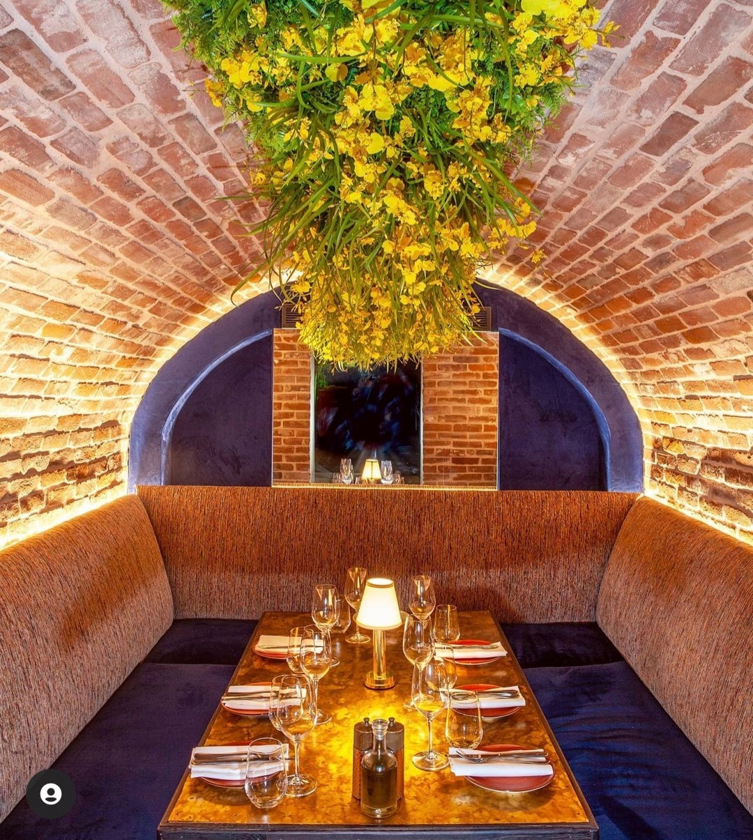 Cozy dining space with brick archway at The Caves, Meraki London for private events.