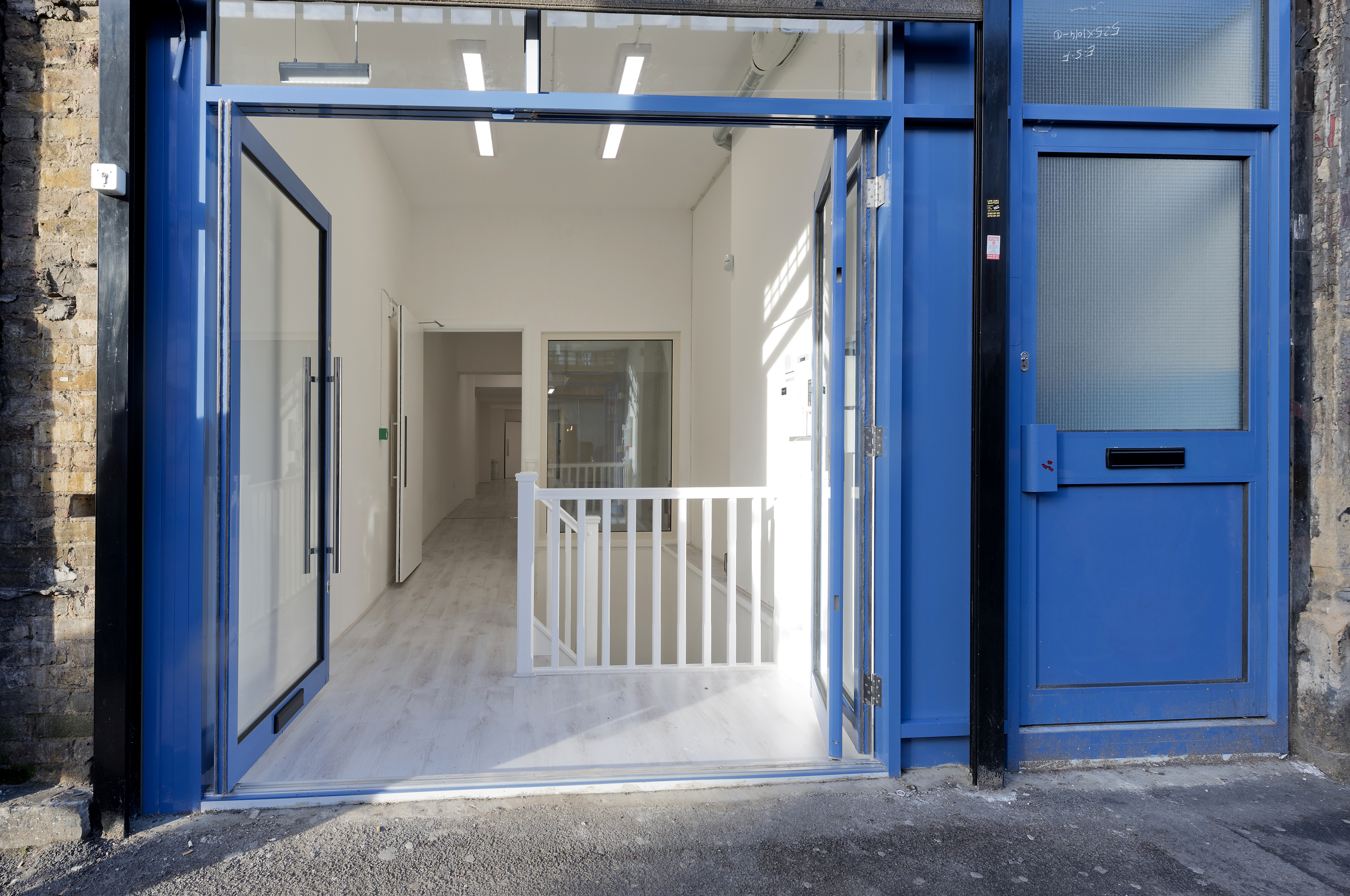 Spacious modern venue entrance with glass doors for corporate events and workshops.