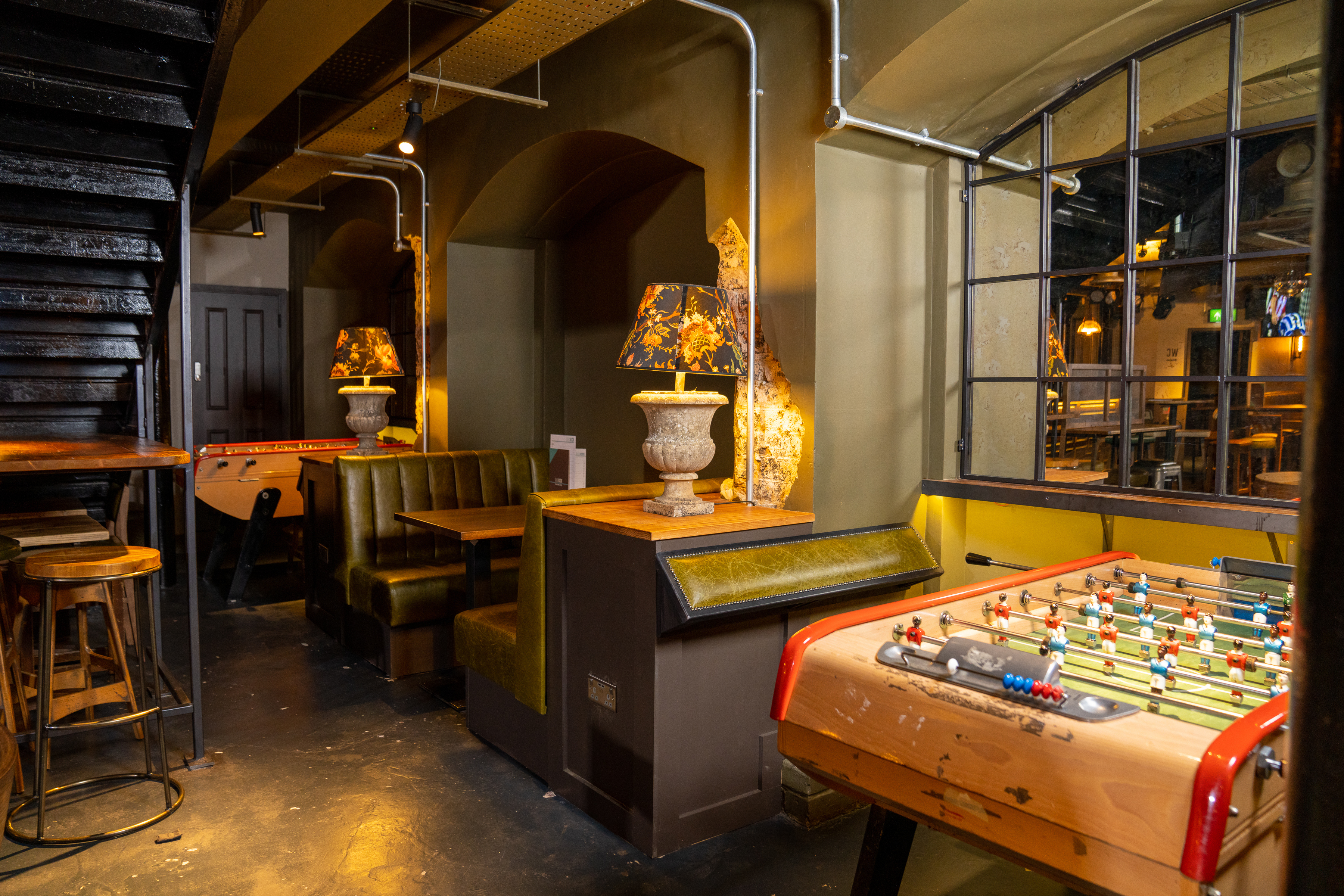 Stylish basement event space with cozy seating, ideal for networking and team-building.