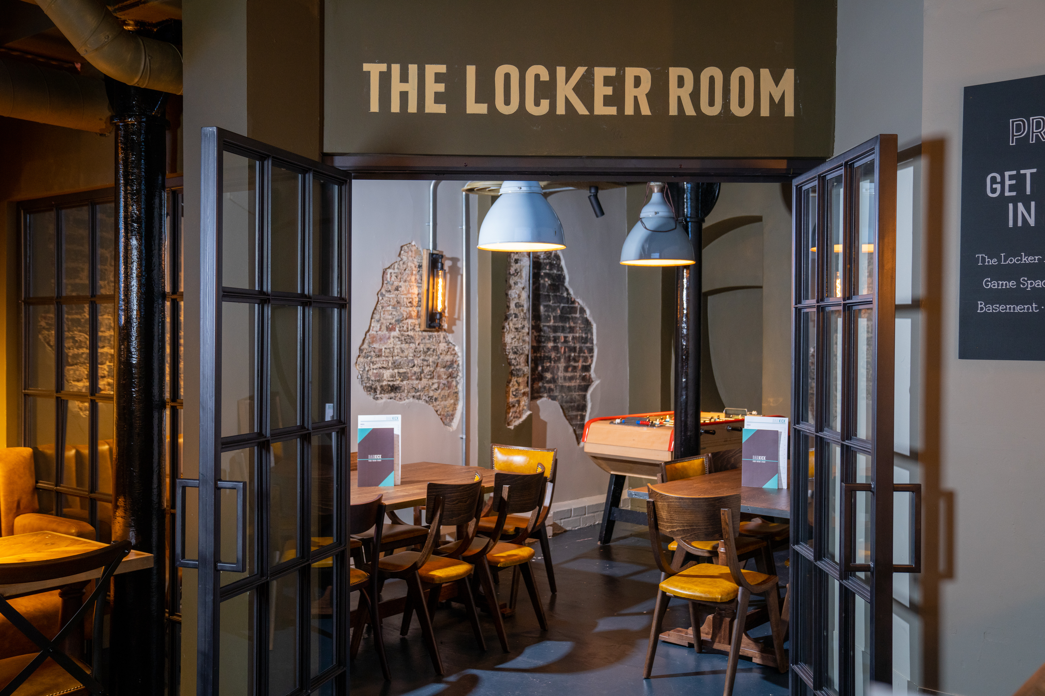 Stylish event space "The Locker Room" with game tables for casual gatherings.