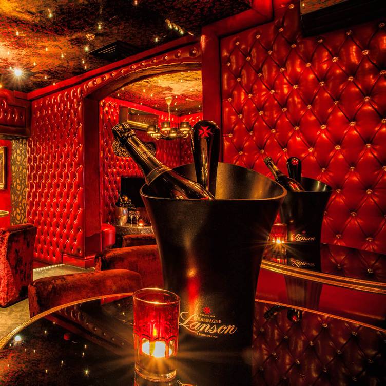 Luxurious Red Room at 1989 Clubhouse, perfect for exclusive events and celebrations.
