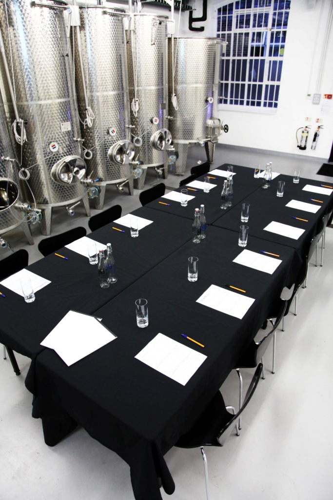 Tank Room at London Cru Winery: modern meeting space with stainless steel tanks, ideal for retreats.