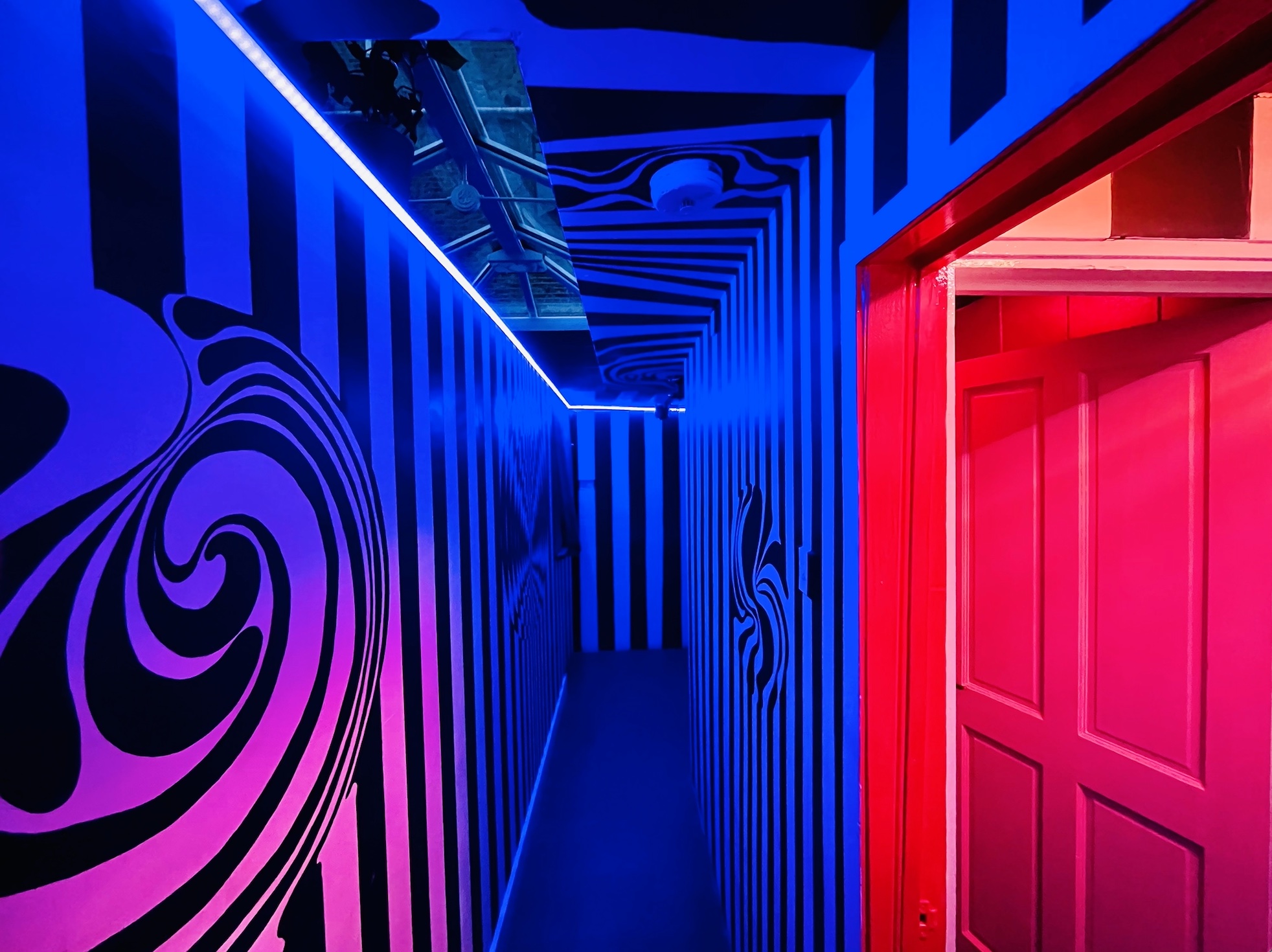 Vibrant hallway at Bonkers Bar with bold stripes, ideal for events and gatherings.