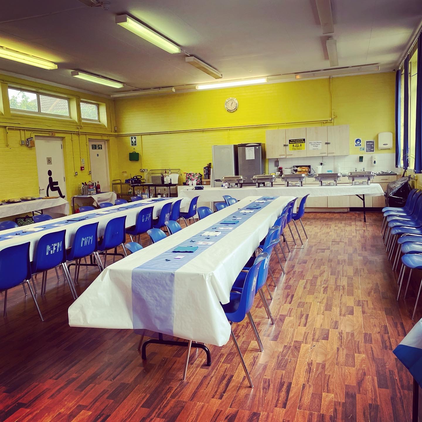 William Hall event space with blue and white tables, perfect for banquets or meetings.