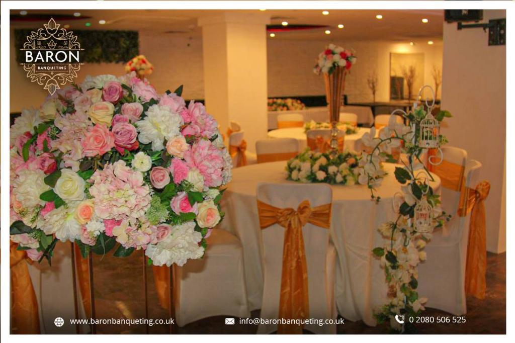 Elegant Baron Lounge event space with floral centerpieces, perfect for weddings and gatherings.