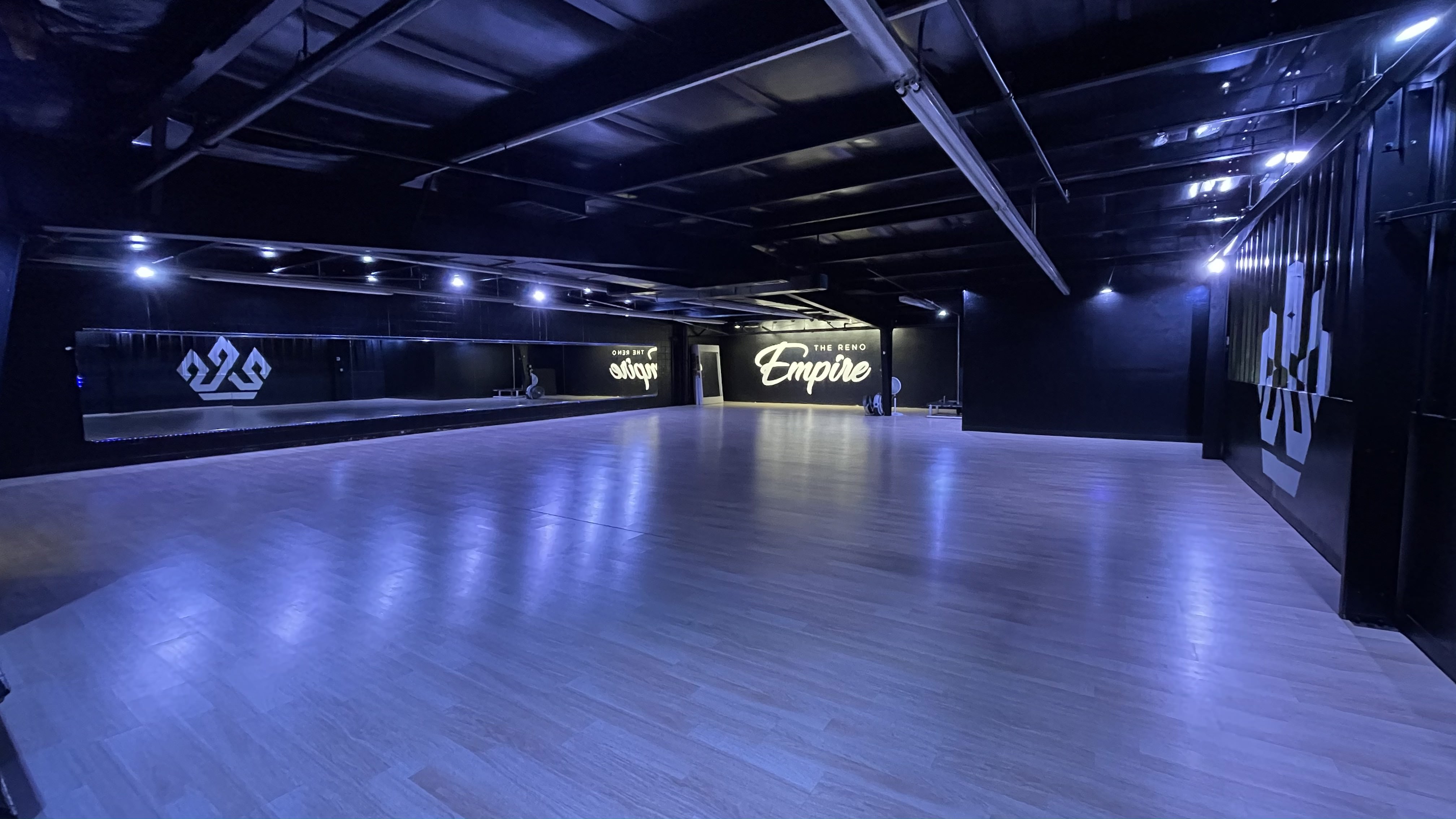Spacious Reno Empire venue with polished wood floor, ideal for events and gatherings.