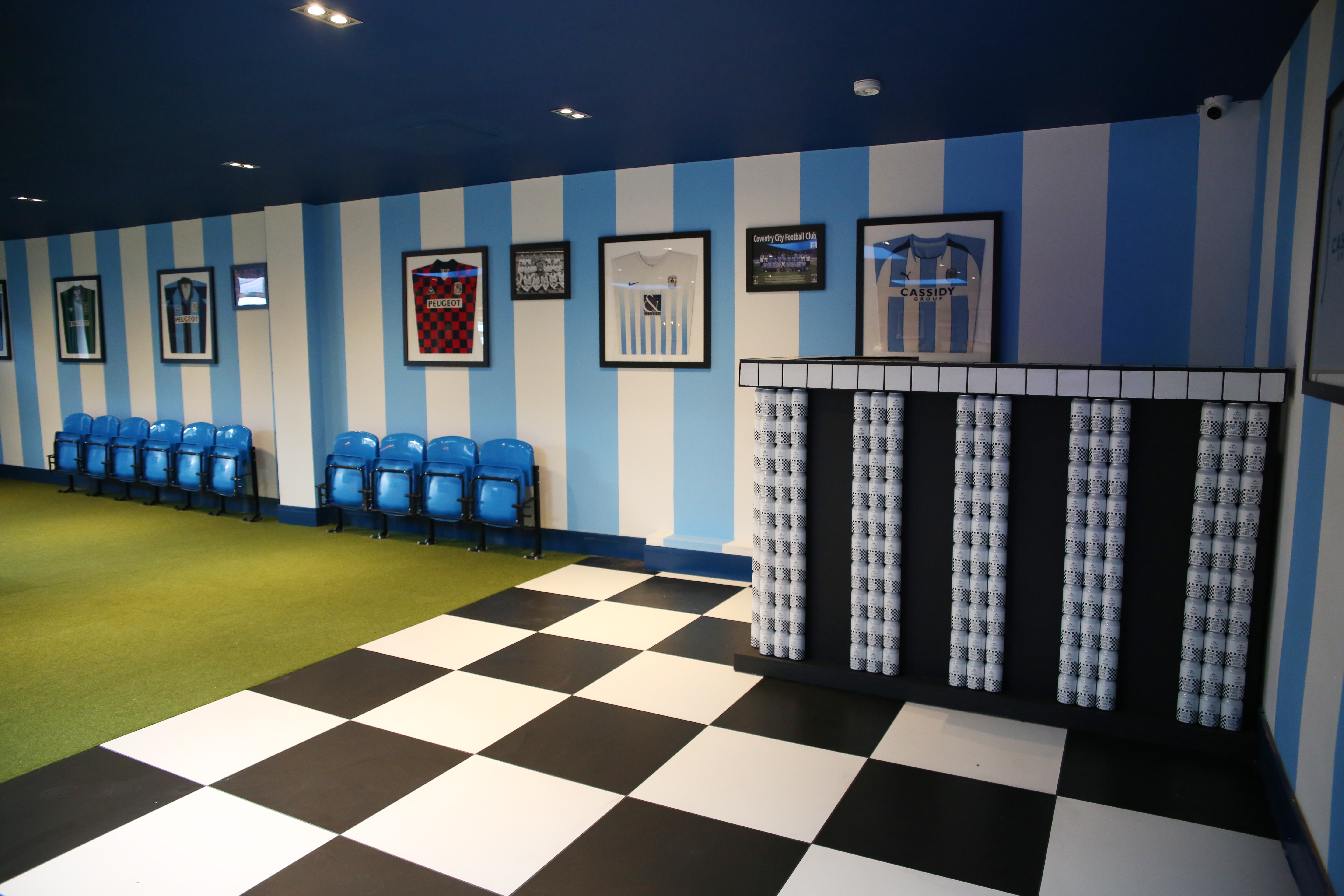 Vibrant sports-themed event space with striped walls at Sky Blue Tavern.
