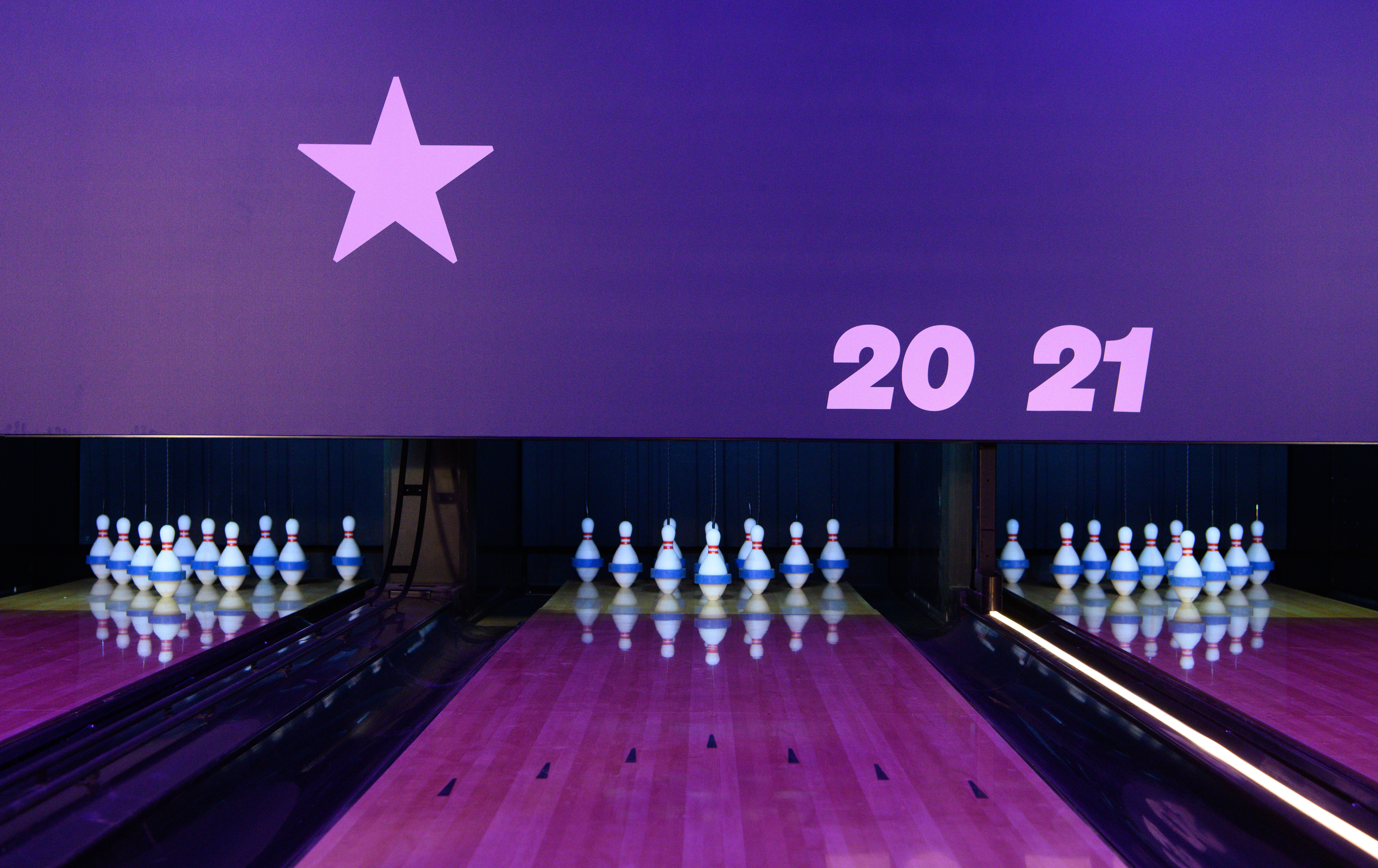 Duckpin Lounge bowling alley at O2 London, vibrant lights for events and team-building.