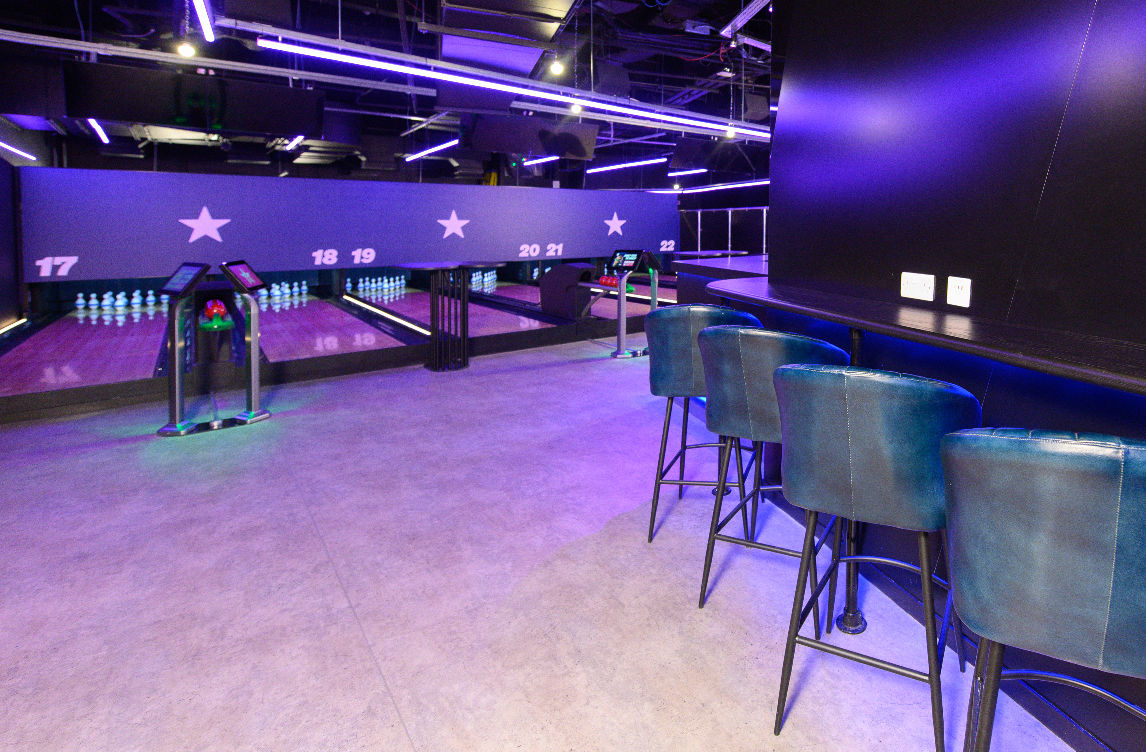Duckpin Lounge at O2: vibrant bowling alley with neon lights for corporate events.