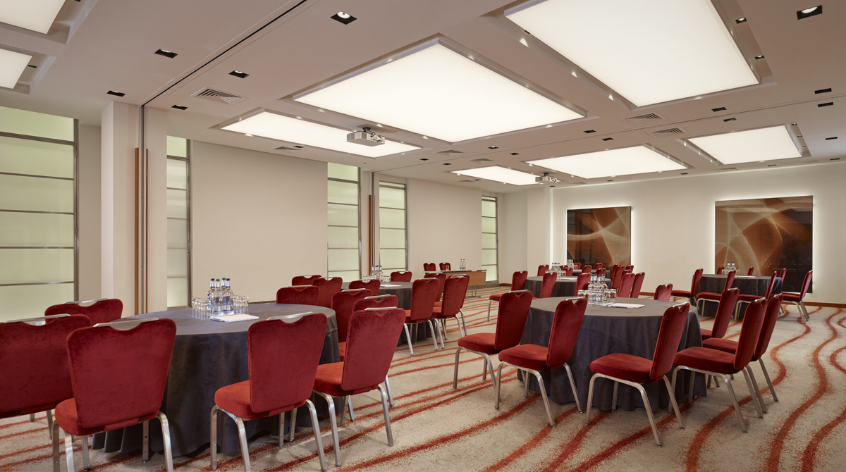 Edward Suite at Park Plaza Victoria London, modern meeting space with round tables, corporate events.