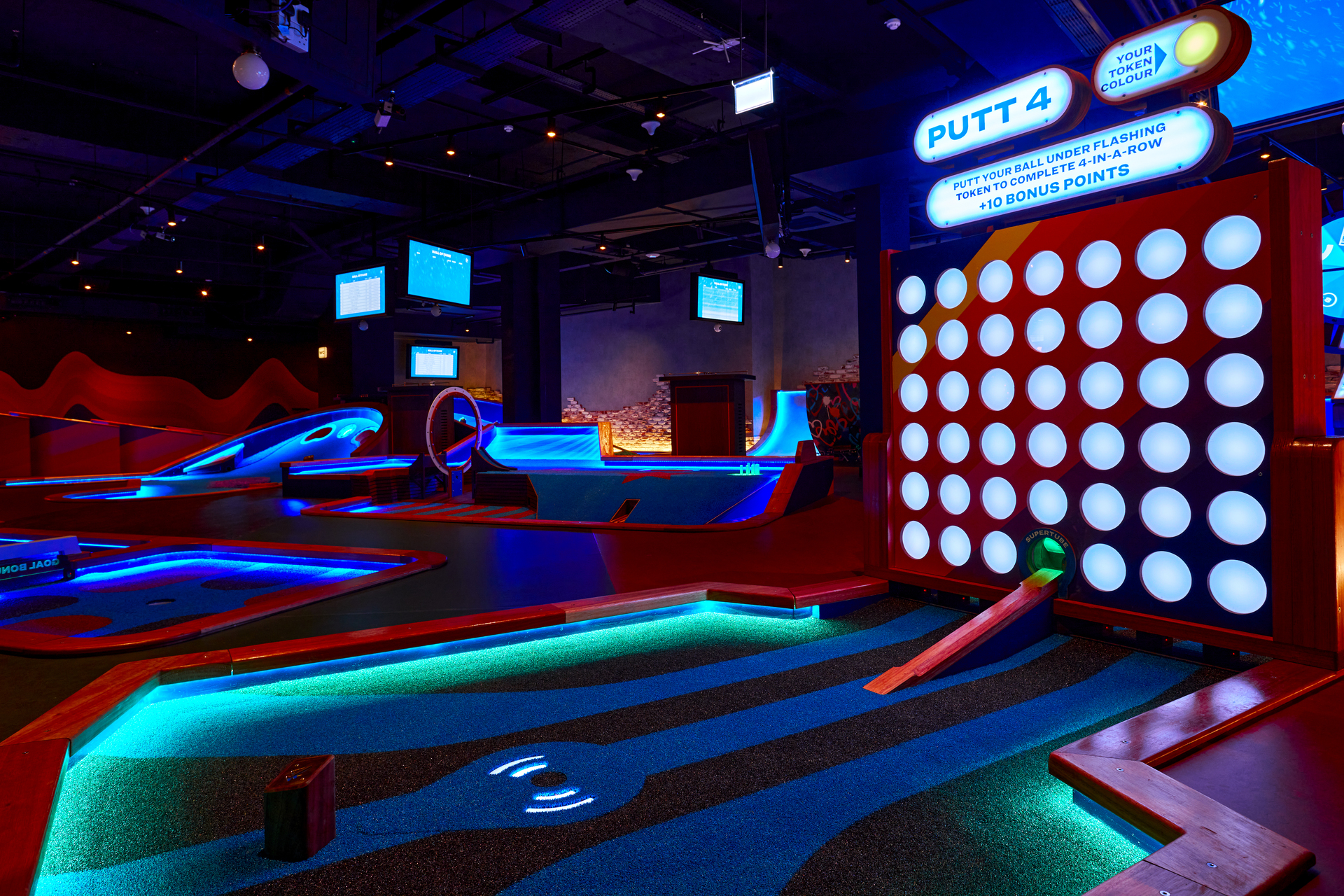 Topaz private room at Puttshack Watford, vibrant mini-golf venue for events.