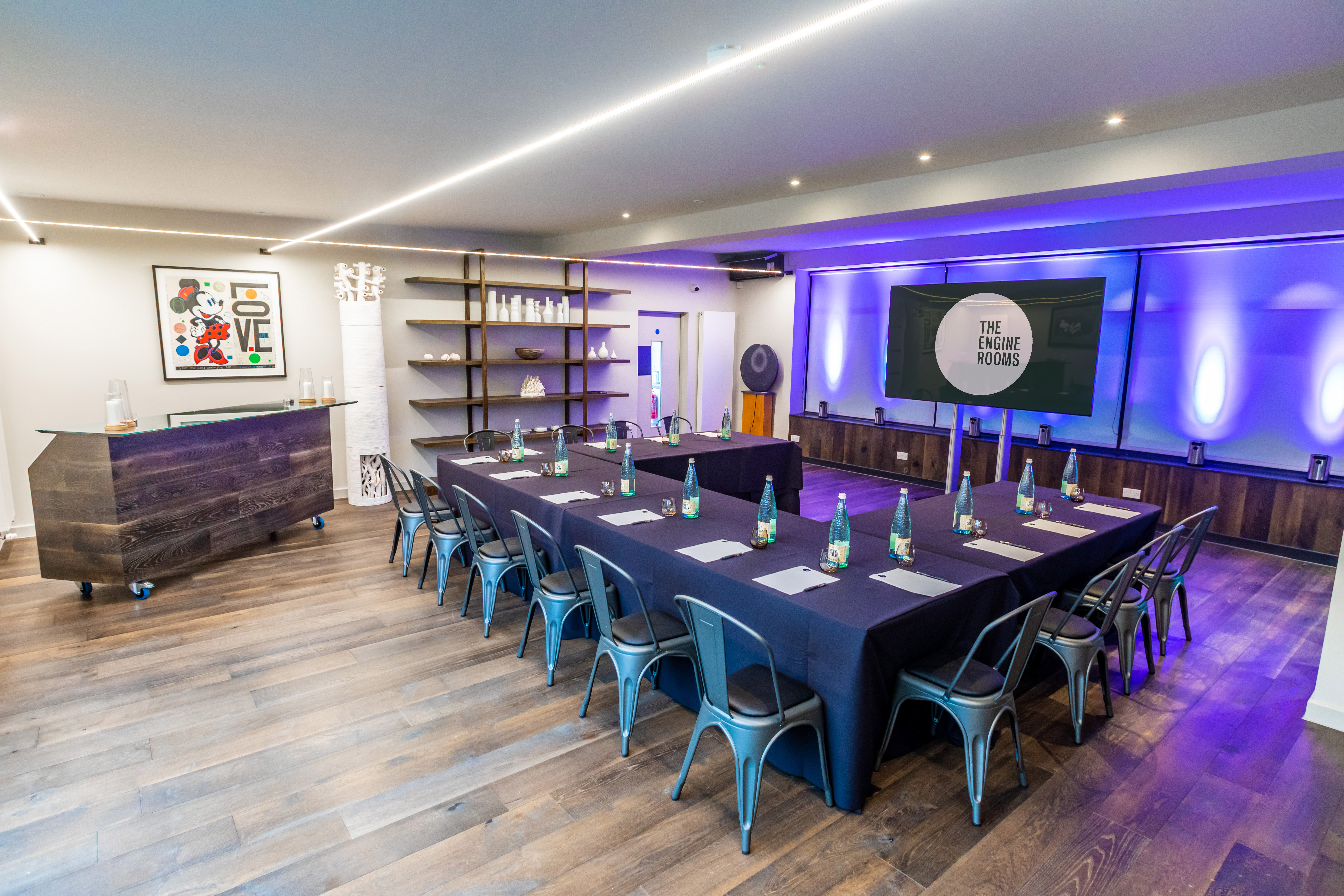 Modern meeting space with large table, ideal for professional gatherings and presentations.