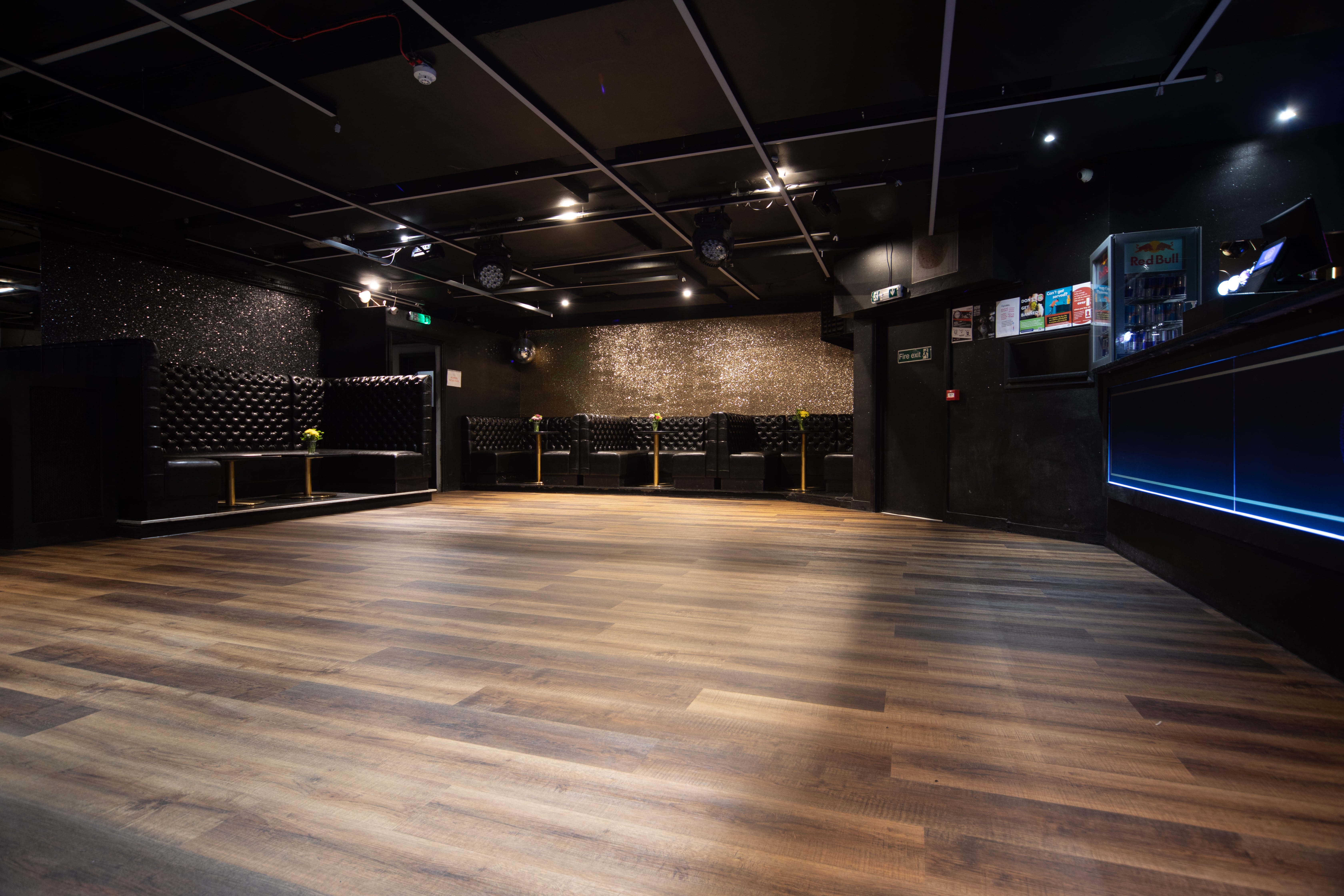 Main Room at Aura Tunbridge Wells: modern event space with elegant dark walls, ideal for gatherings.