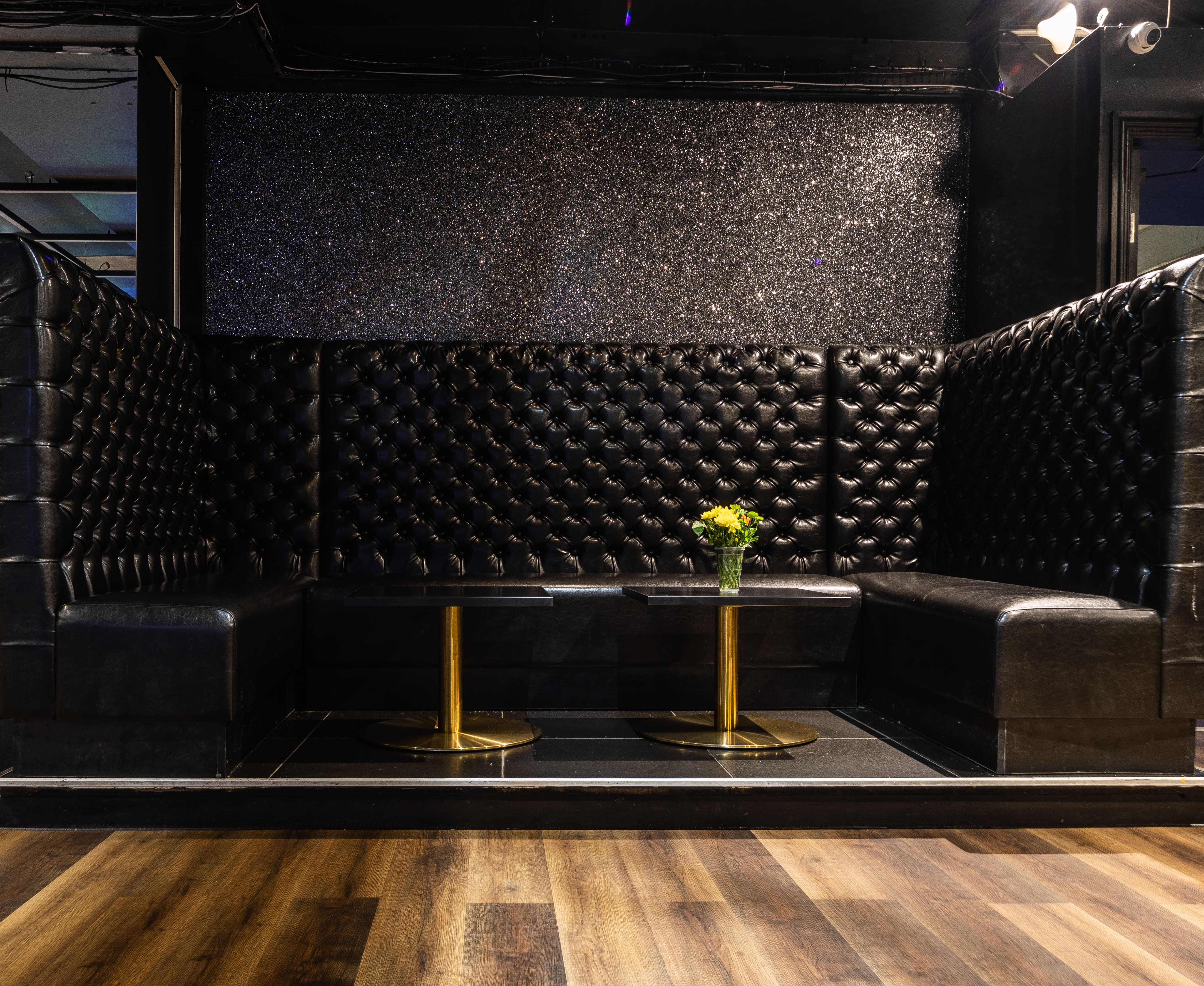 Stylish lounge with plush black seating, ideal for upscale events and networking.
