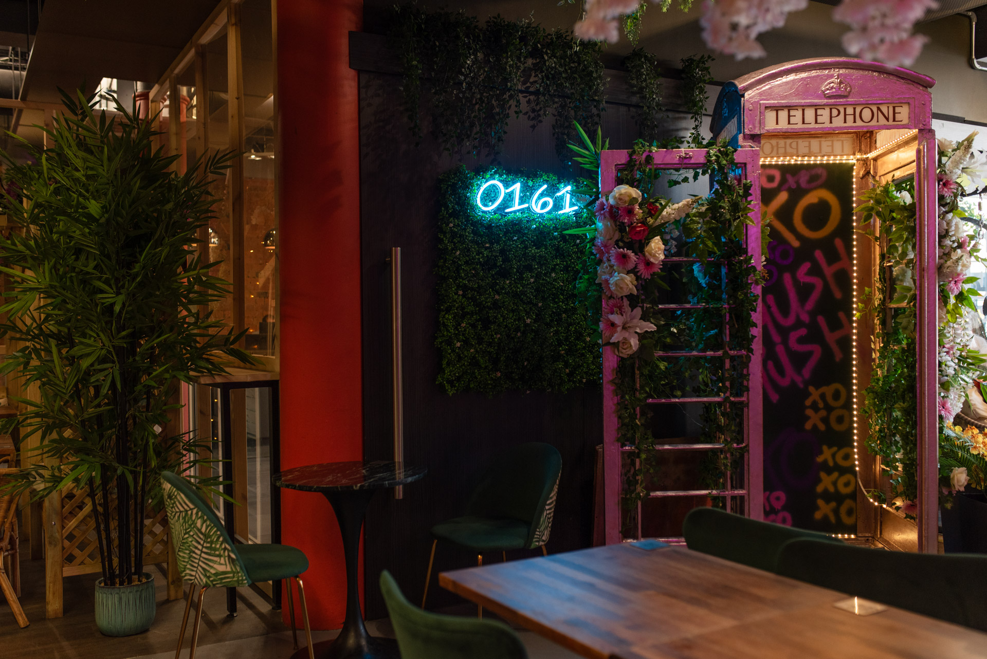 Vibrant event space with floral retro booth, perfect for networking and gatherings.