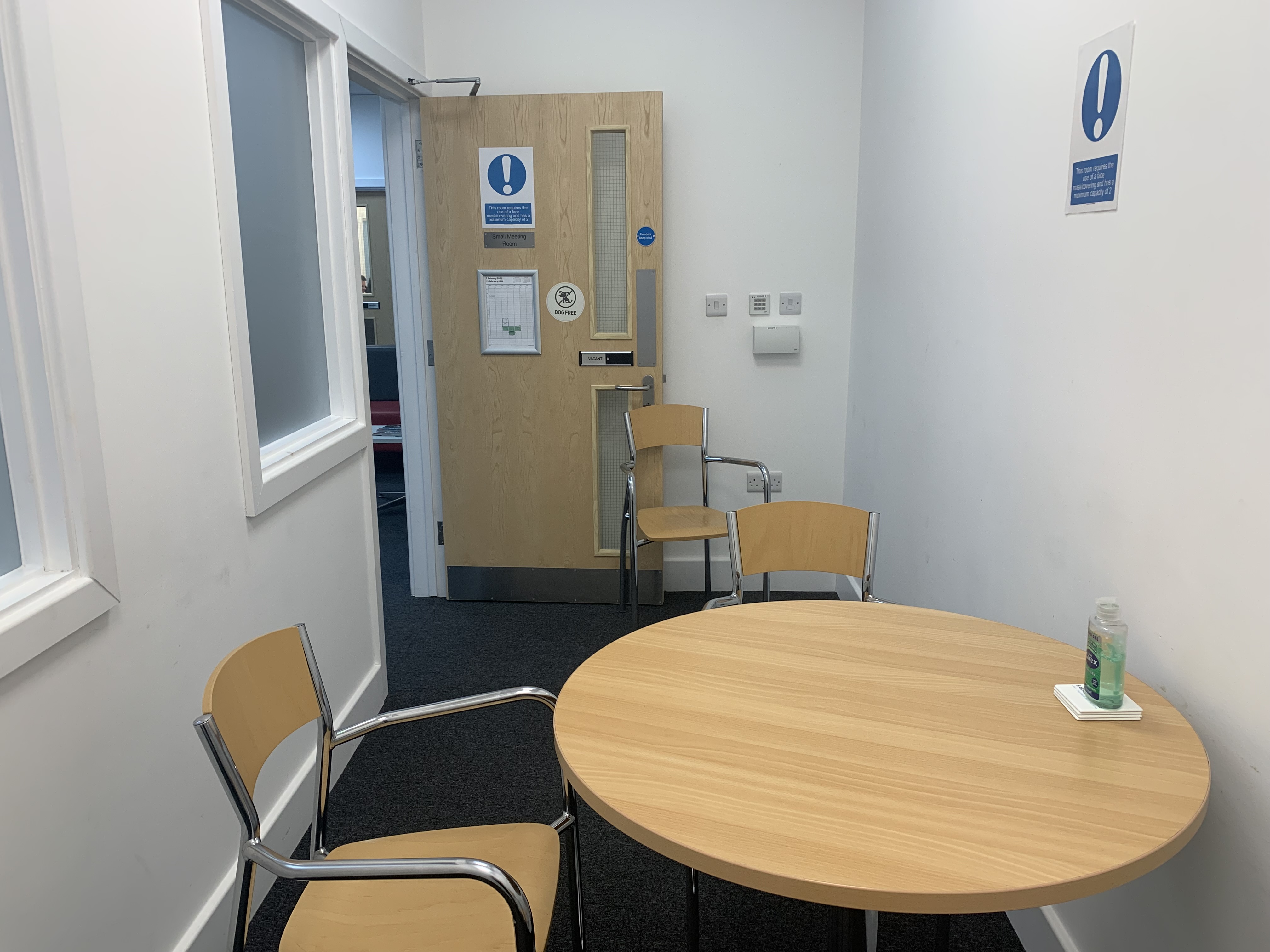 Small meeting room with round table for intimate discussions and professional events.