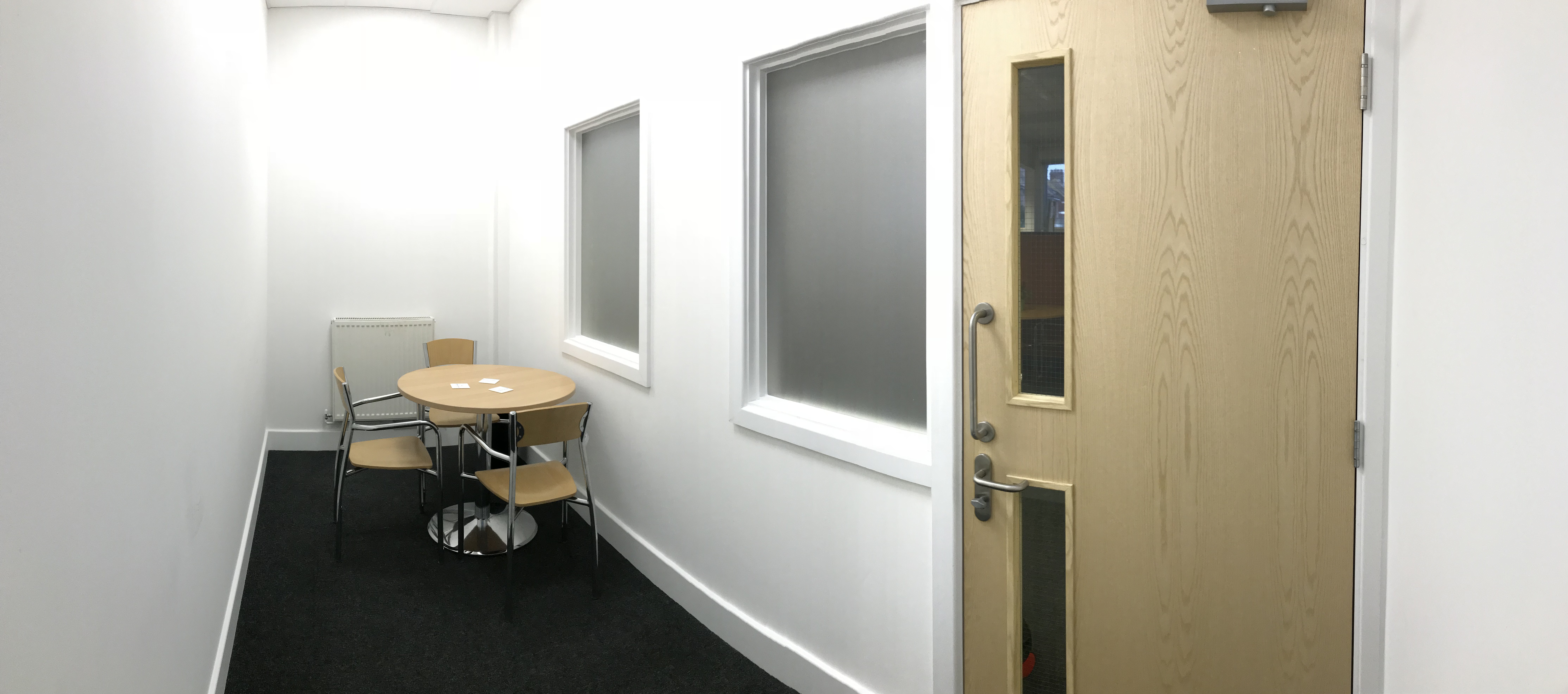 Small Meeting Room in Faraday House with round table for intimate brainstorming sessions.