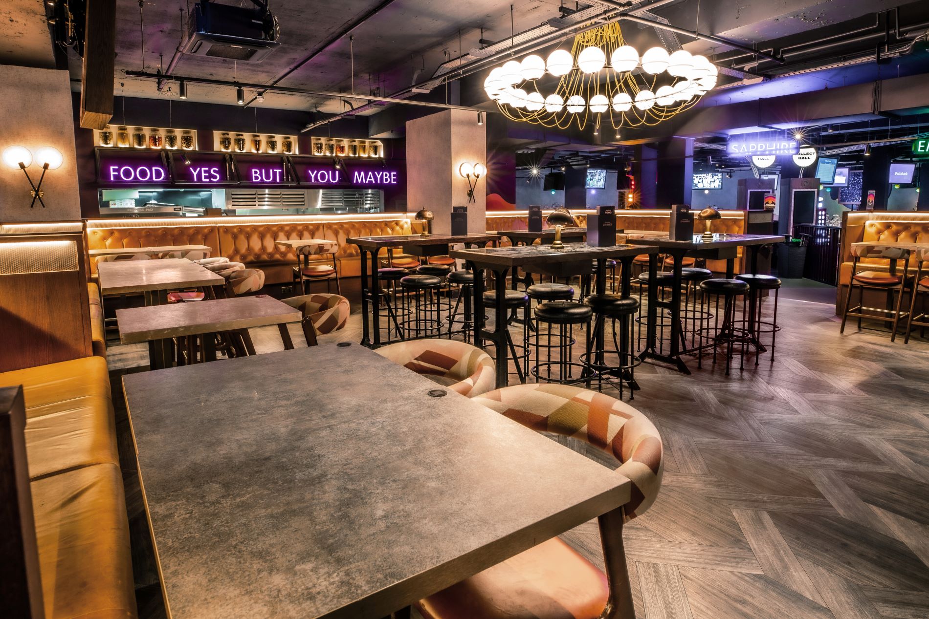 "Christmas event at Puttshack Watford with stylish seating and festive decor."