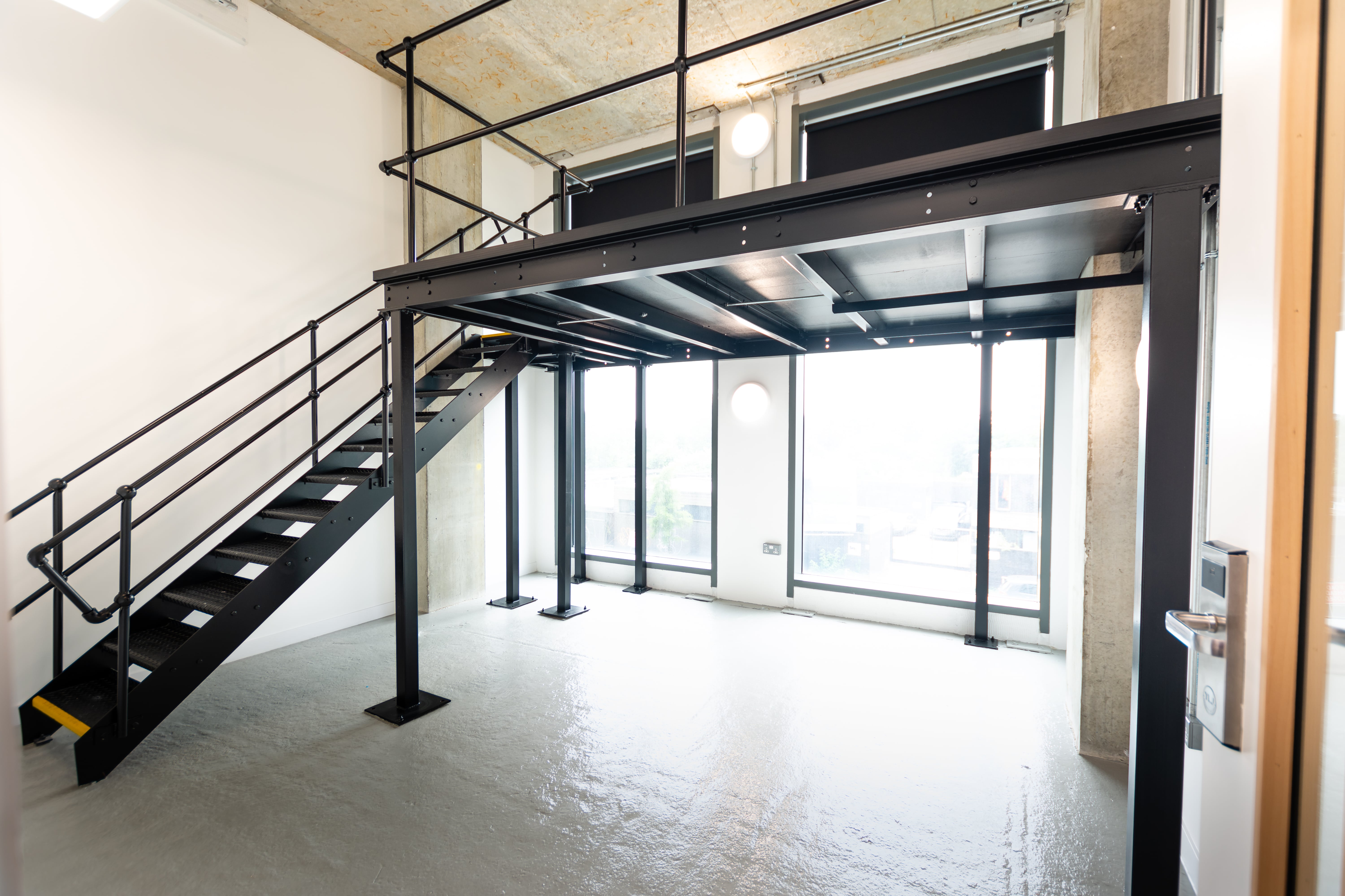 Creative office space with high ceilings, ideal for workshops and networking events.