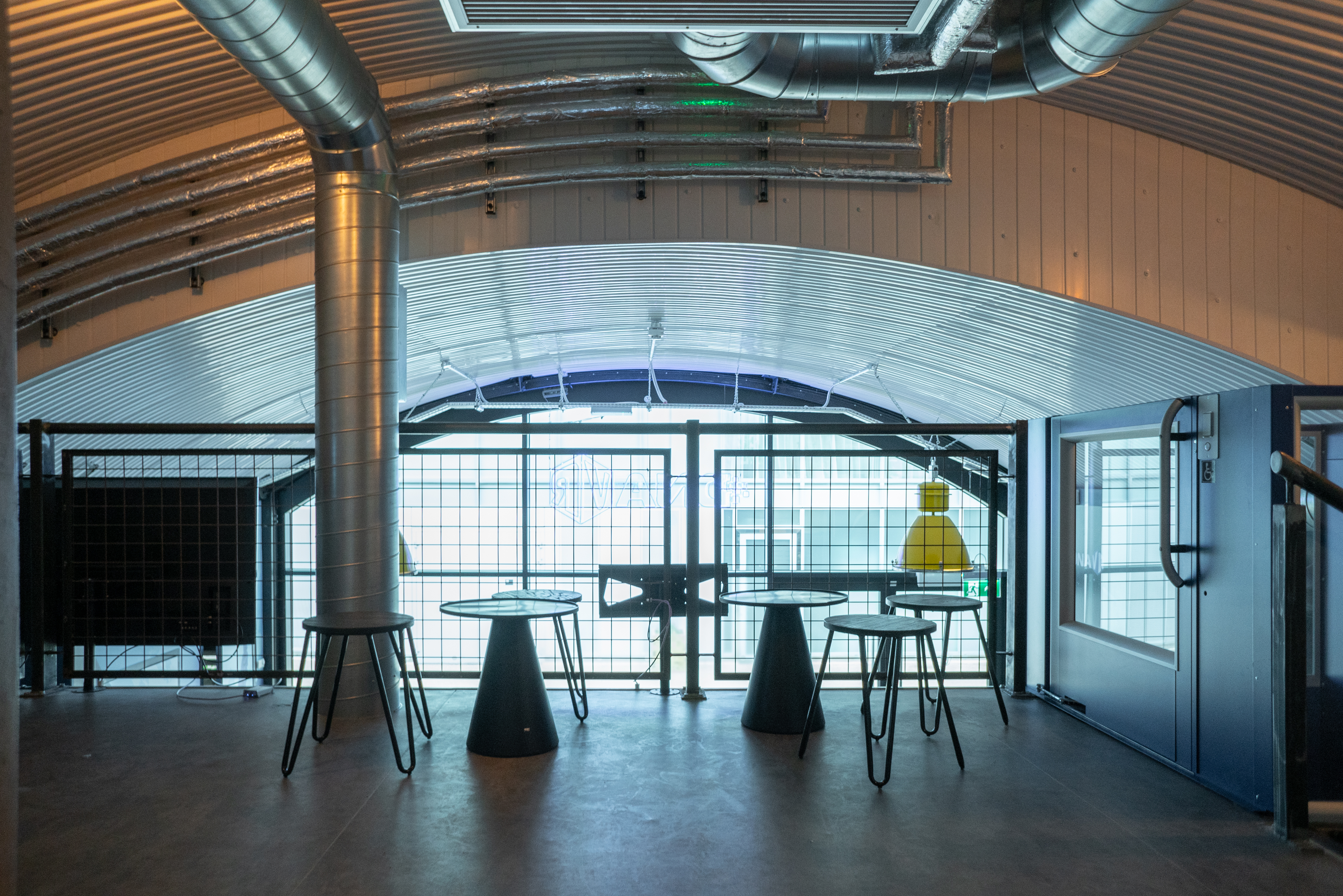 DNA VR Battersea Power Station: modern meeting space with high-top tables for networking events.