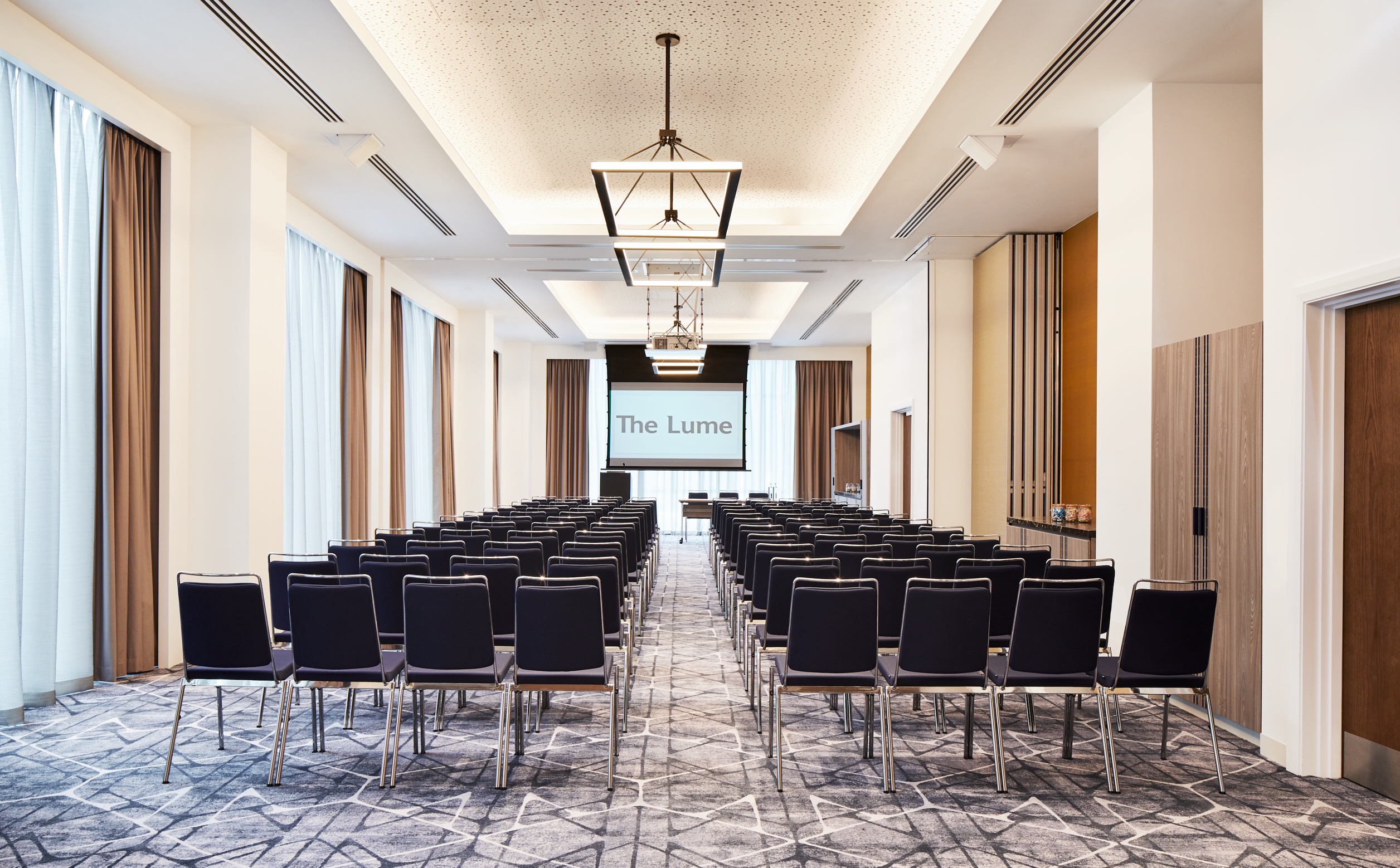 Bernstein Suite conference room with black chairs, ideal for corporate events and workshops.