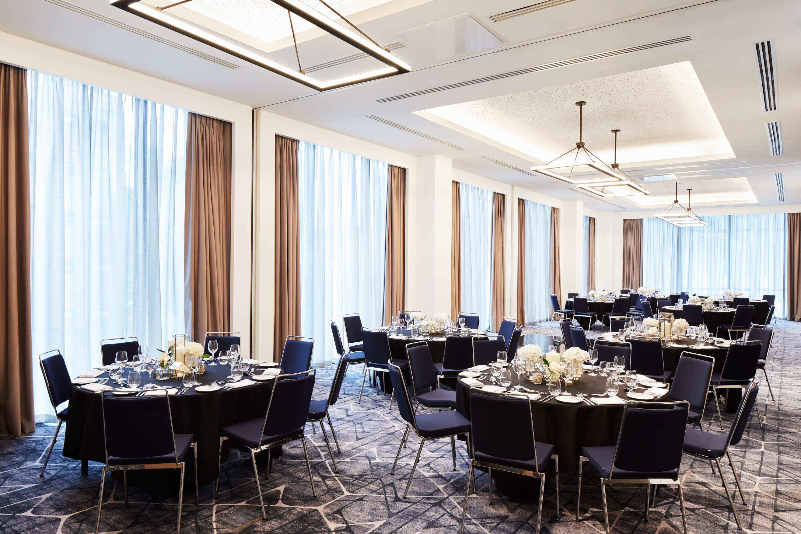 Elegant event space in Hyatt Regency Manchester with round tables for corporate events and weddings.
