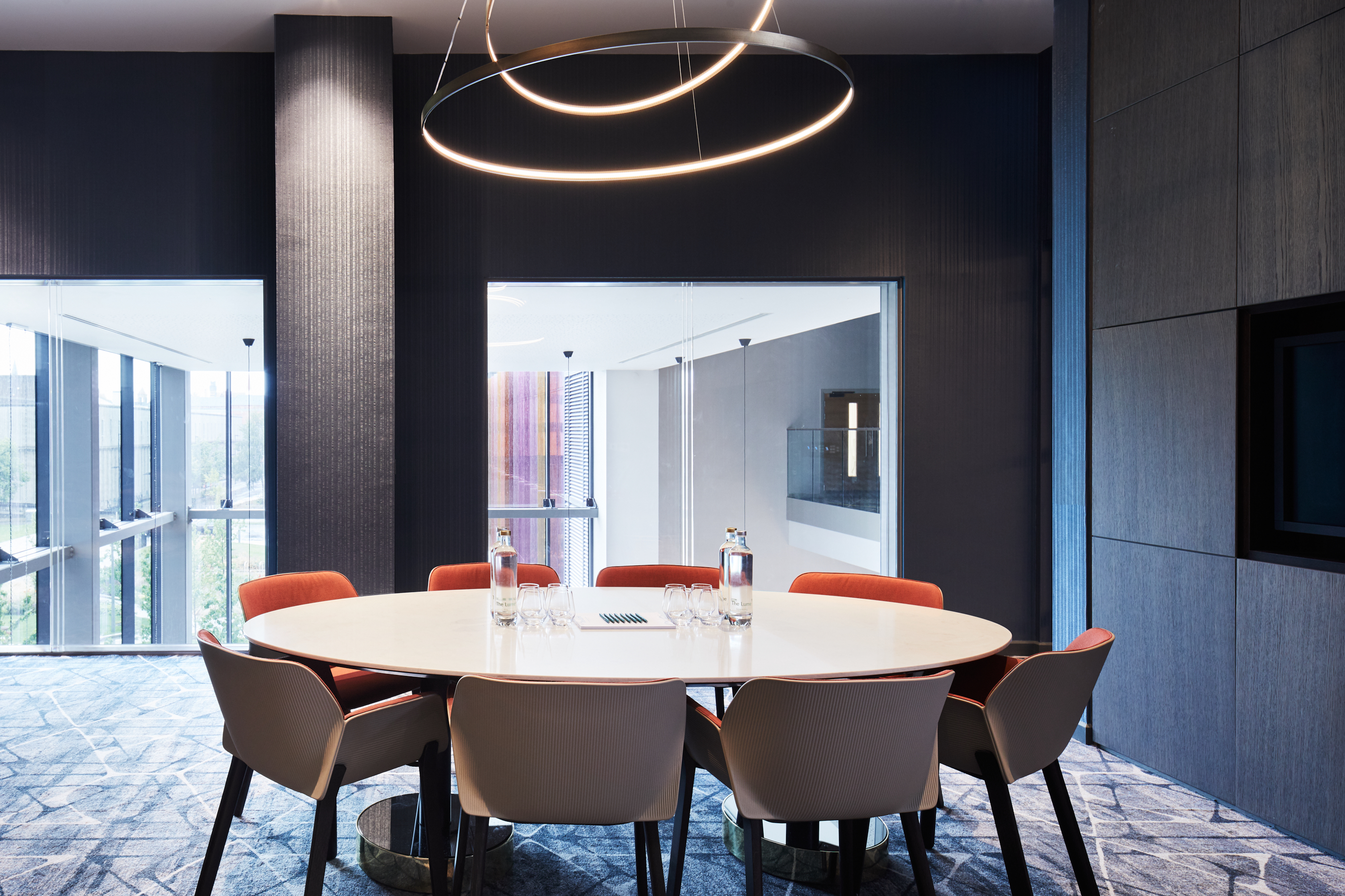 Modern meeting room with round table at Hyatt Regency Manchester for collaborative events.