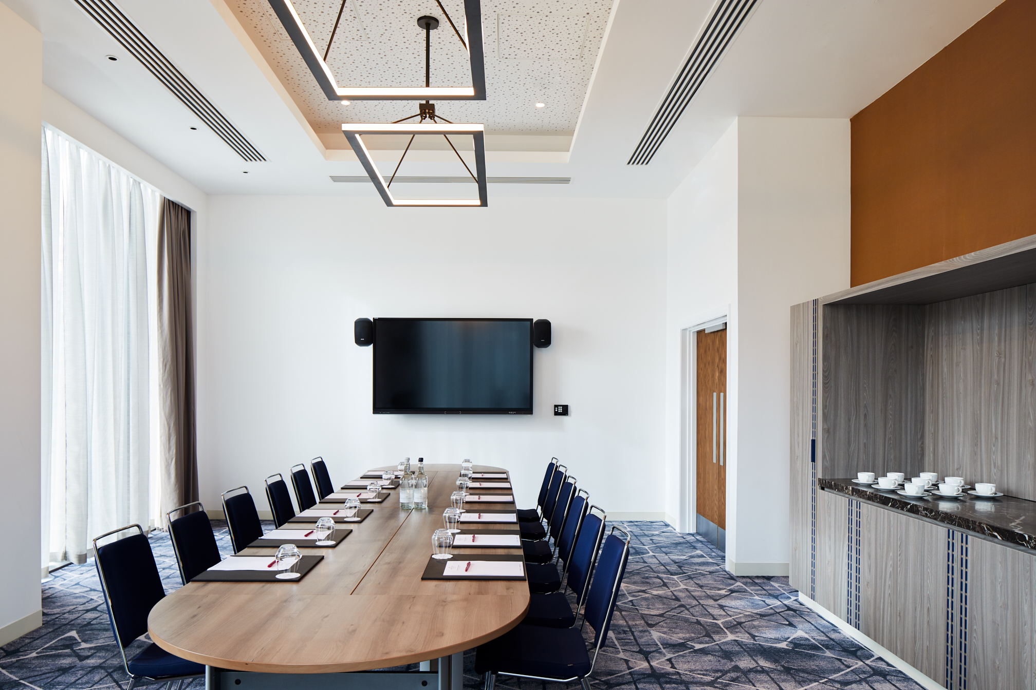 Modern Executive Boardroom at Hyatt Regency Manchester, ideal for meetings and presentations.