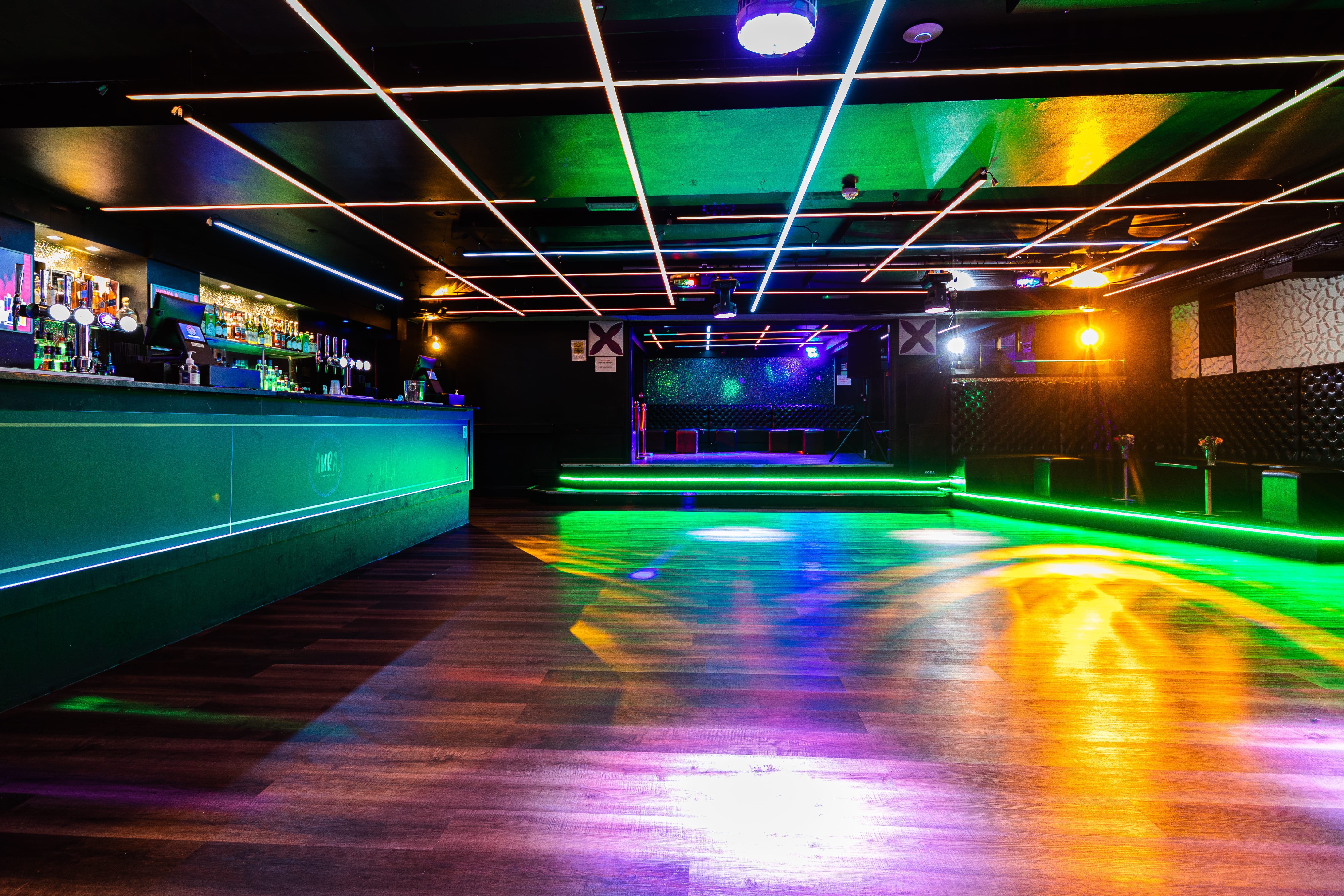 Main Room at Aura Tunbridge Wells: modern event space with vibrant lighting for gatherings.