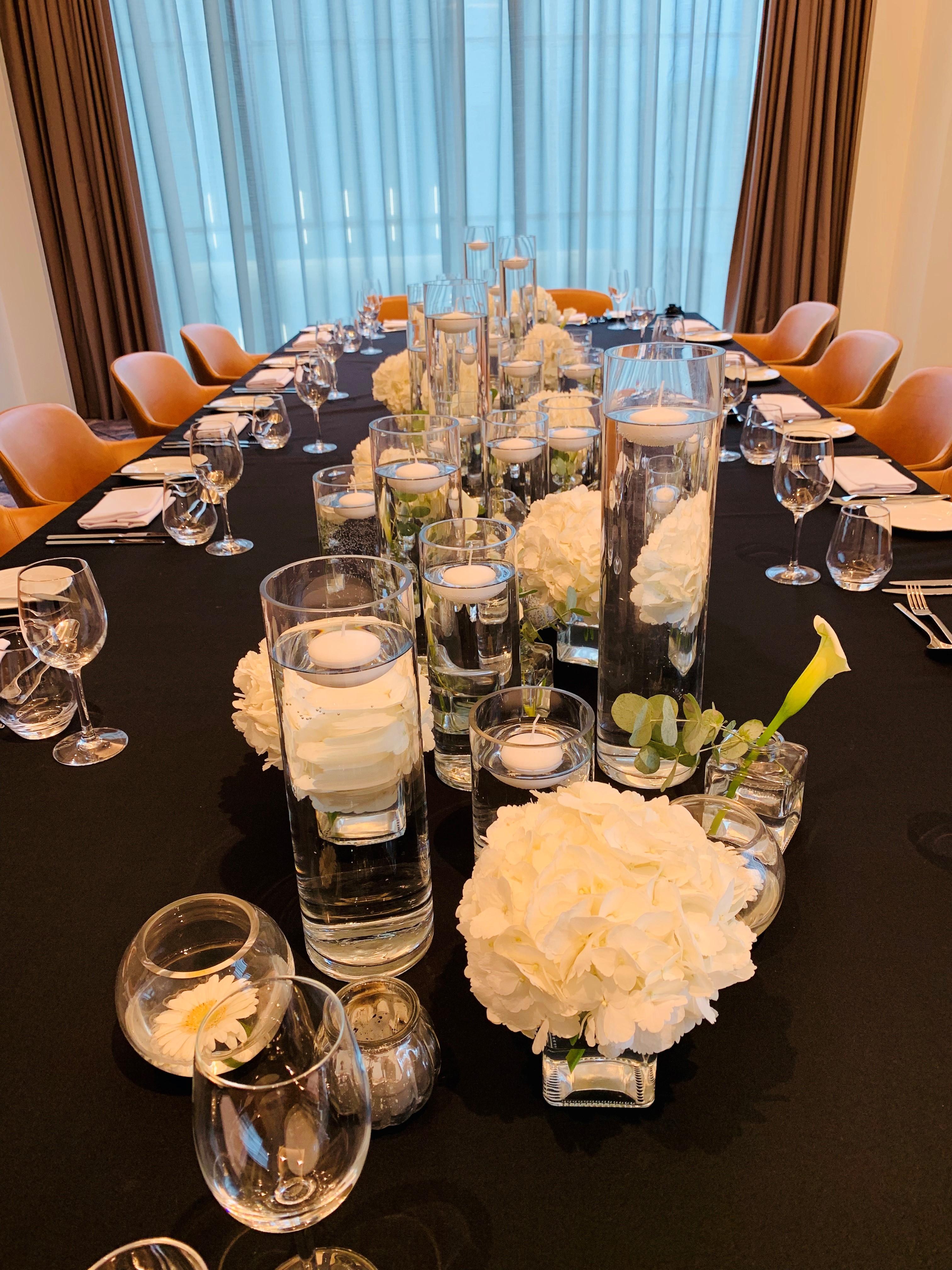 Elegant table setting with floral centerpieces in The Eddington Room, Hyatt Regency Manchester.