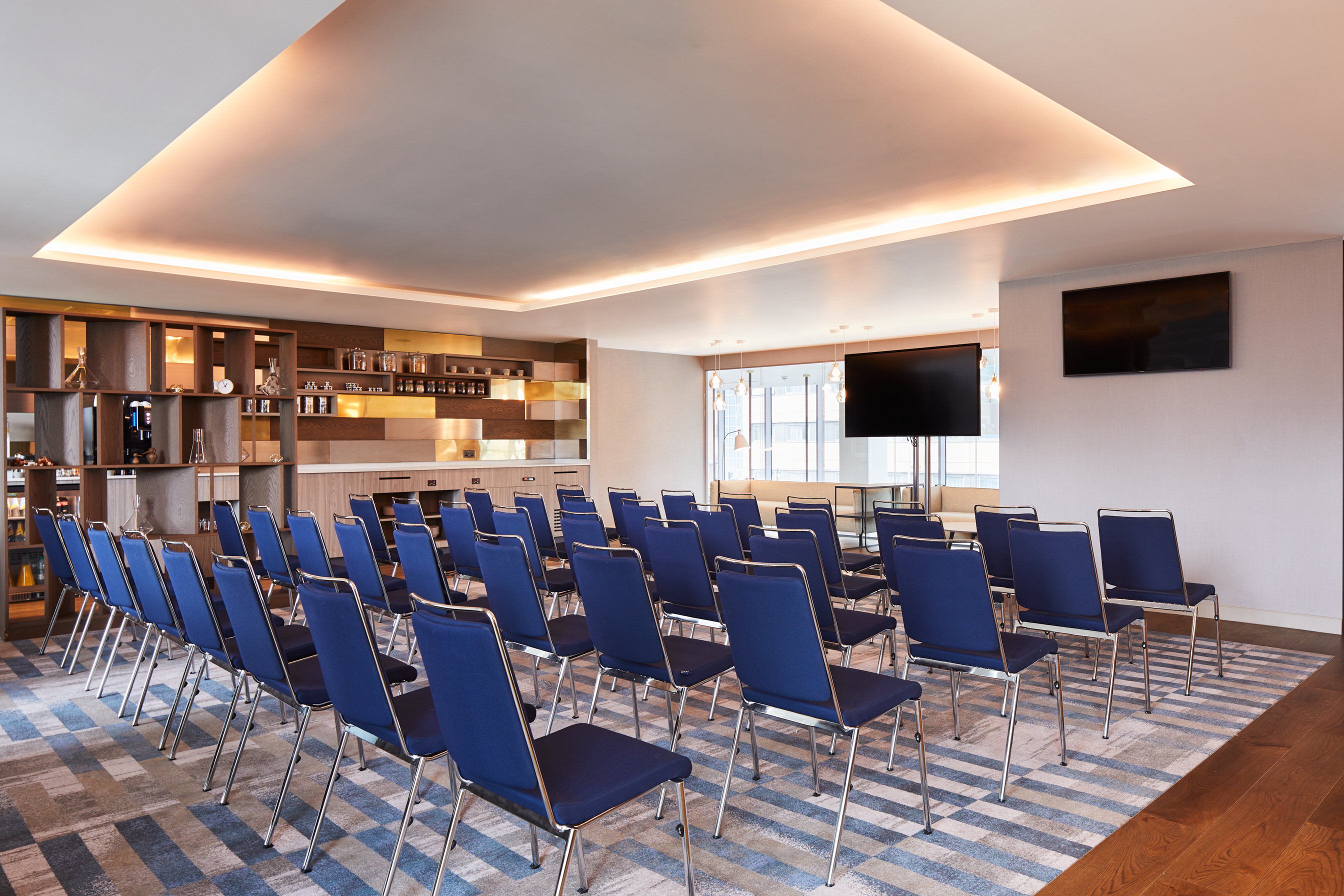 Modern meeting space in Hyatt Regency Manchester with blue chairs for corporate events.