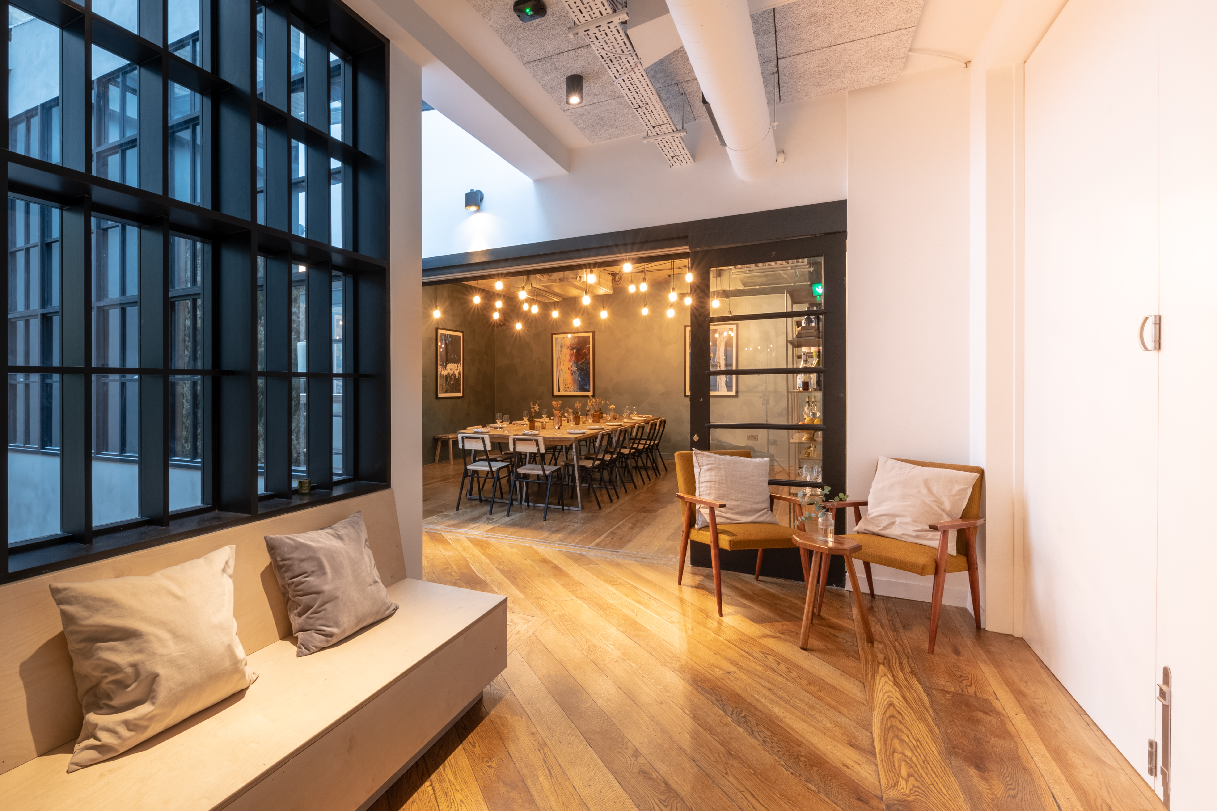 Stylish Green Room in Carousel London, featuring warm wood floors for events and meetings.