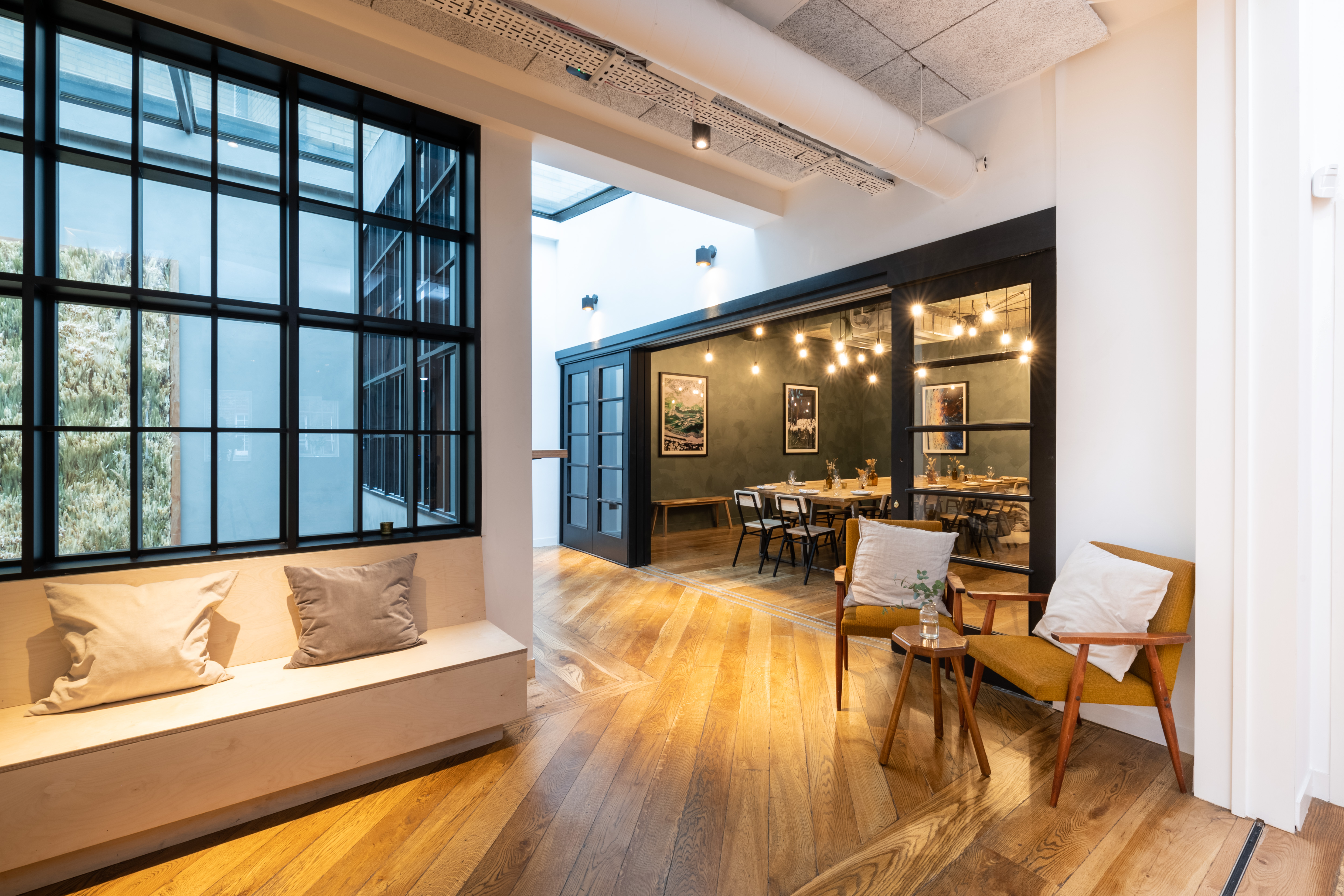 Stylish Green Room in Carousel London with large windows, perfect for meetings and events.