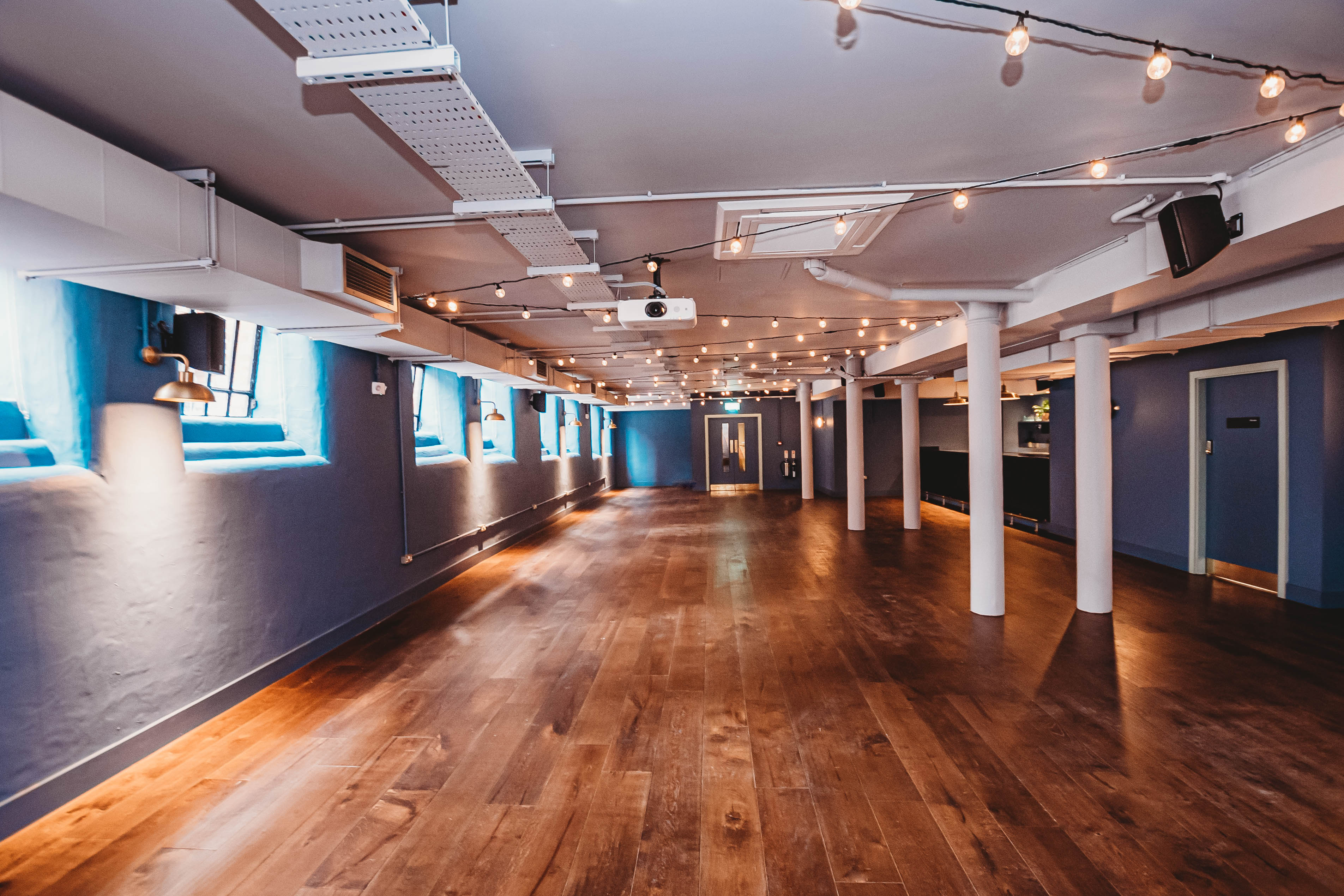 Event space in Whitworth Locke with warm wood flooring for corporate and social gatherings.