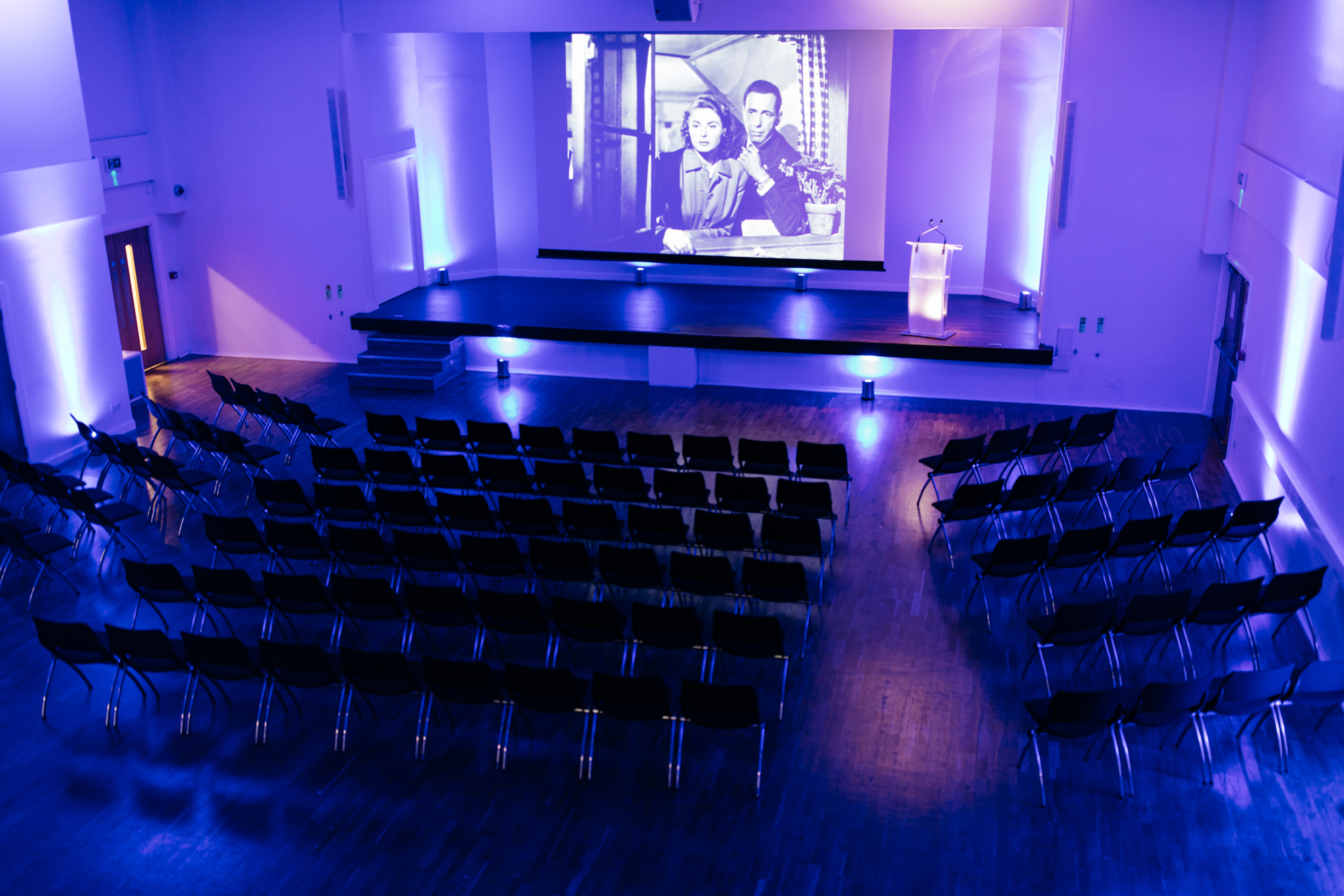 Main Hall in Queens Gate House with purple lighting, ideal for conferences and seminars.