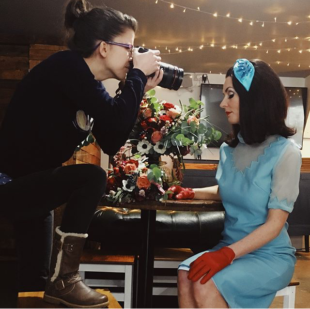 Styled model in floral arrangements at BROWN & BYE's Private Dining Room for events.