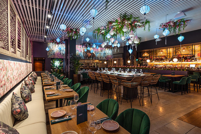 Full restaurant with vibrant decor, ideal for events and networking in Namii Kitchen & Cocktails.