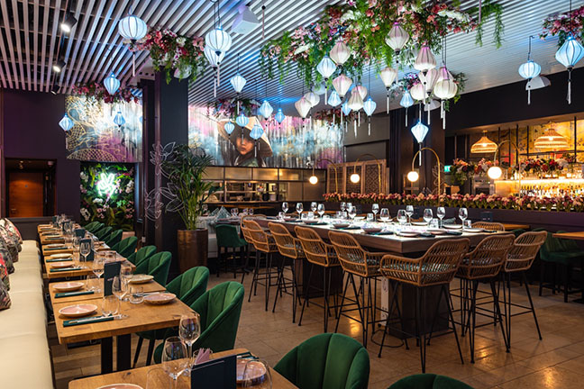 Elegant restaurant interior with floral decor, ideal for events and gatherings.