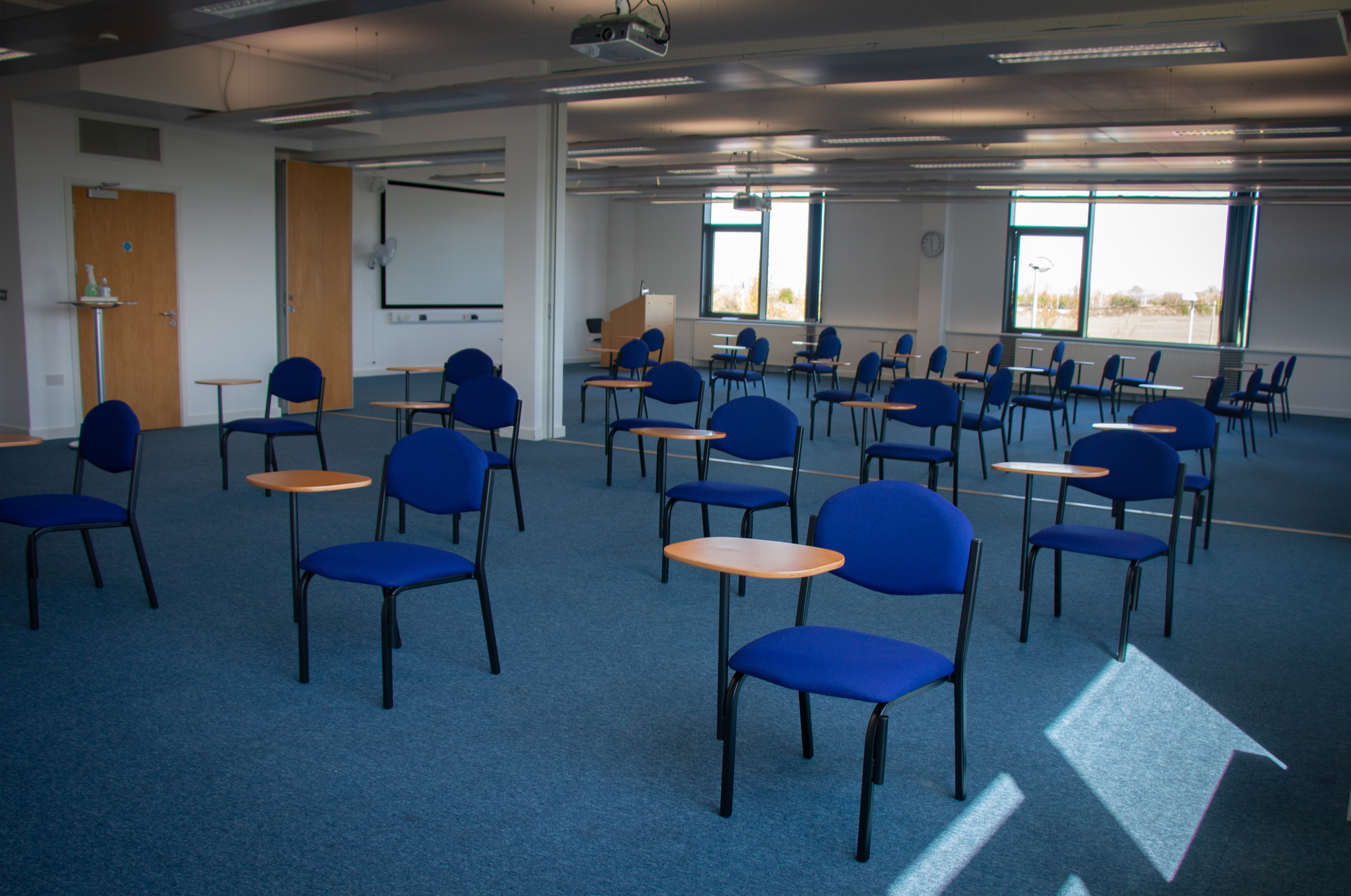 Spacious meeting room with chairs and tables for workshops at Future Skills Centre.