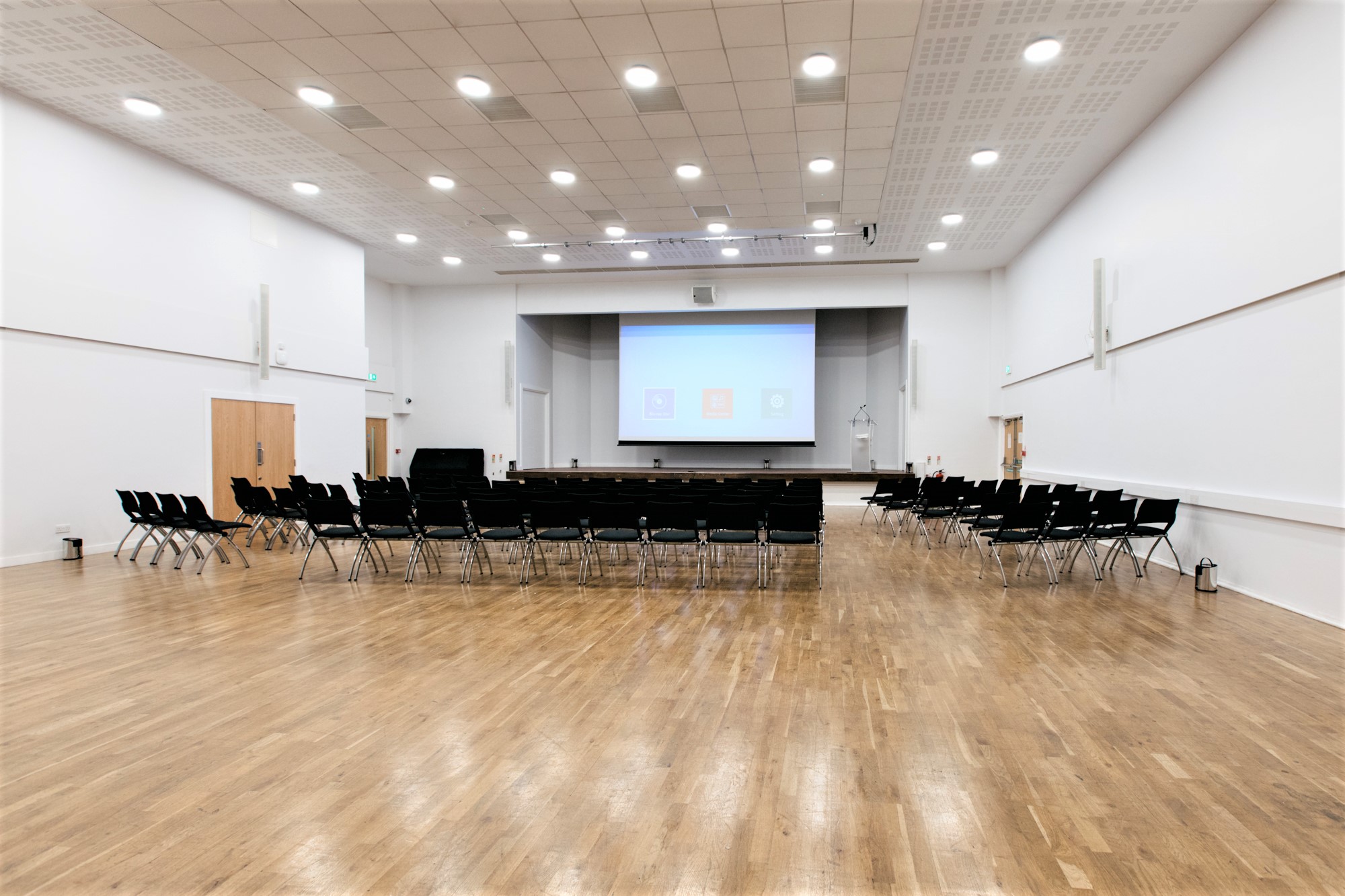 Spacious Main Hall in Queens Gate House set for a presentation with black chairs.