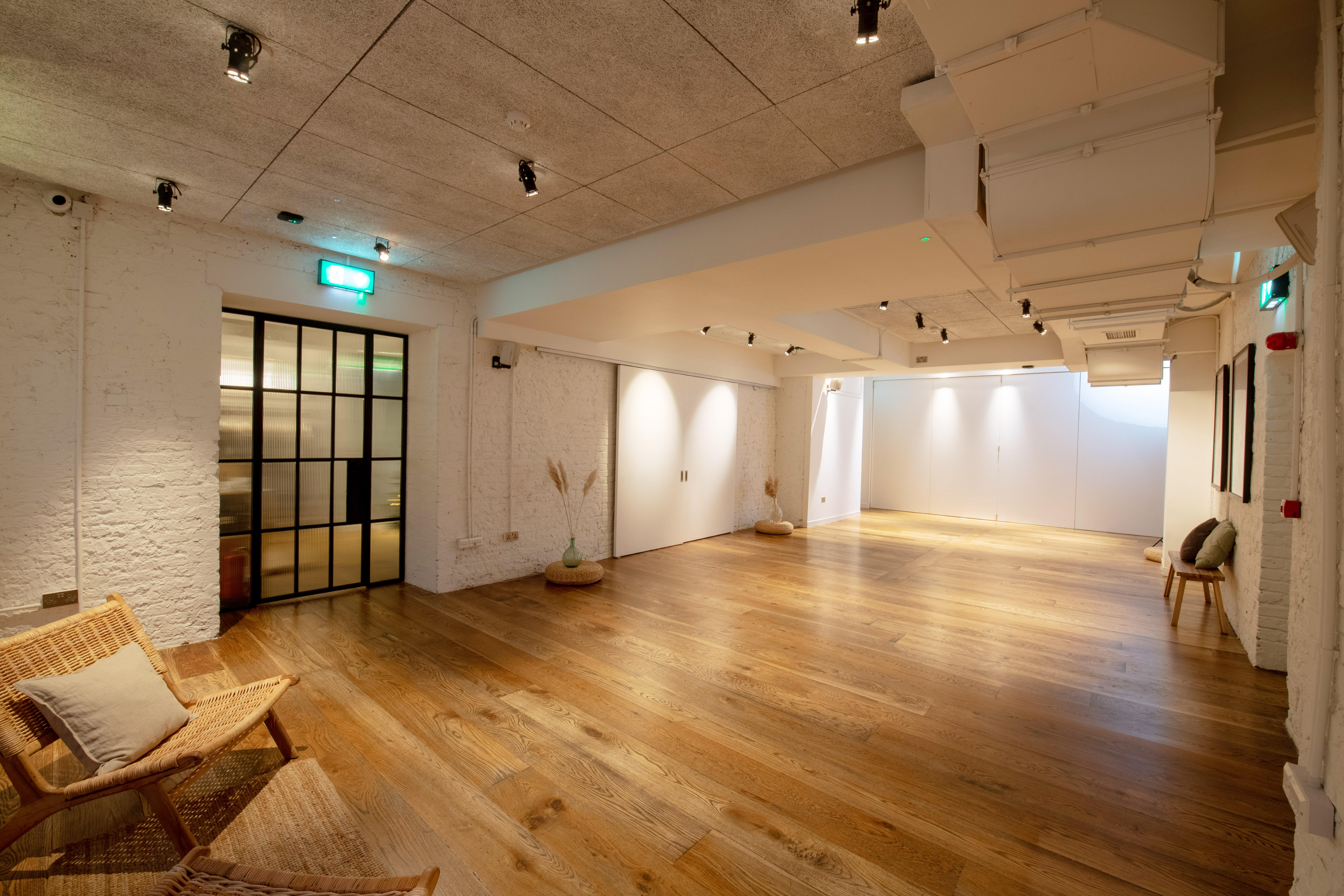 White Room at Carousel London, modern event space with warm wooden flooring for gatherings.